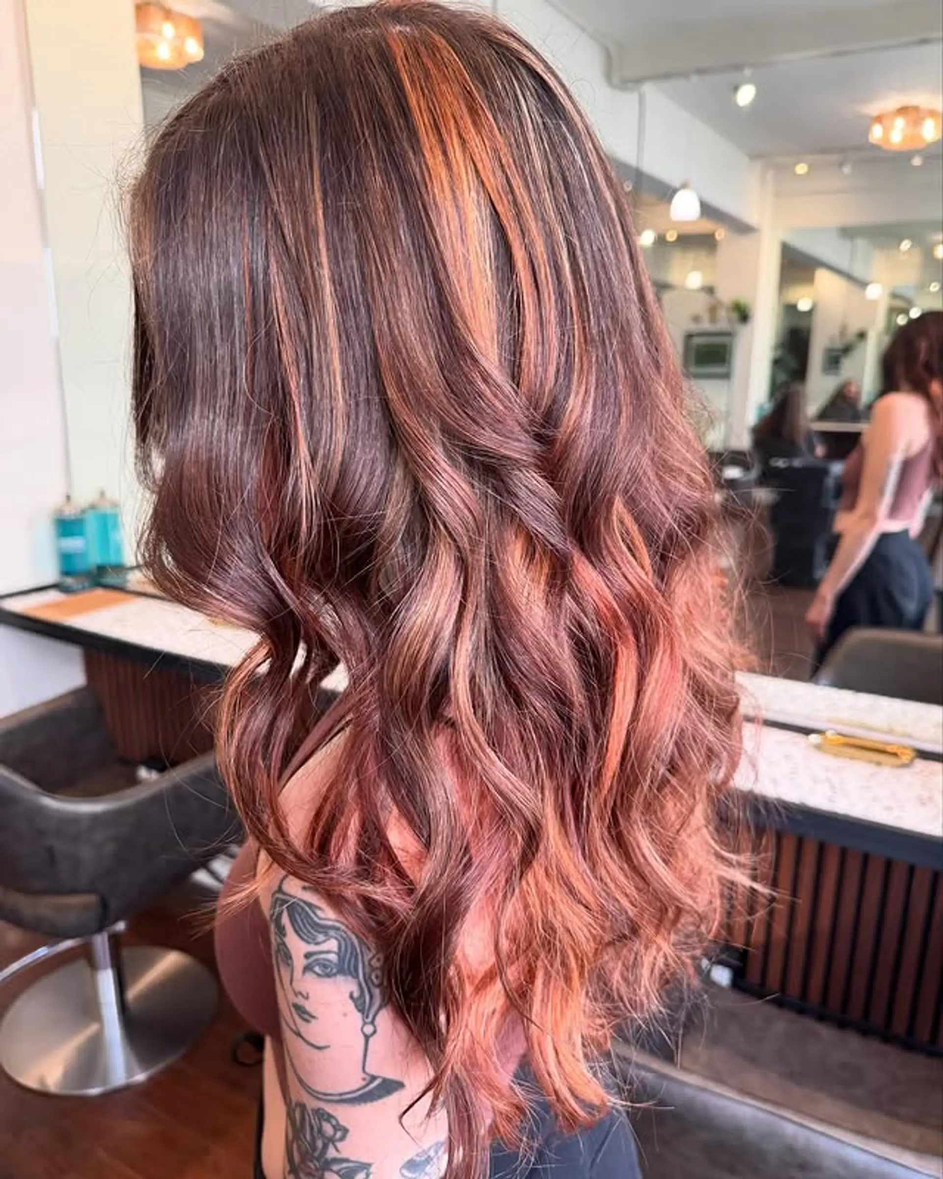 Long wavy hair with copper and light red highlights in a balayage style. 1