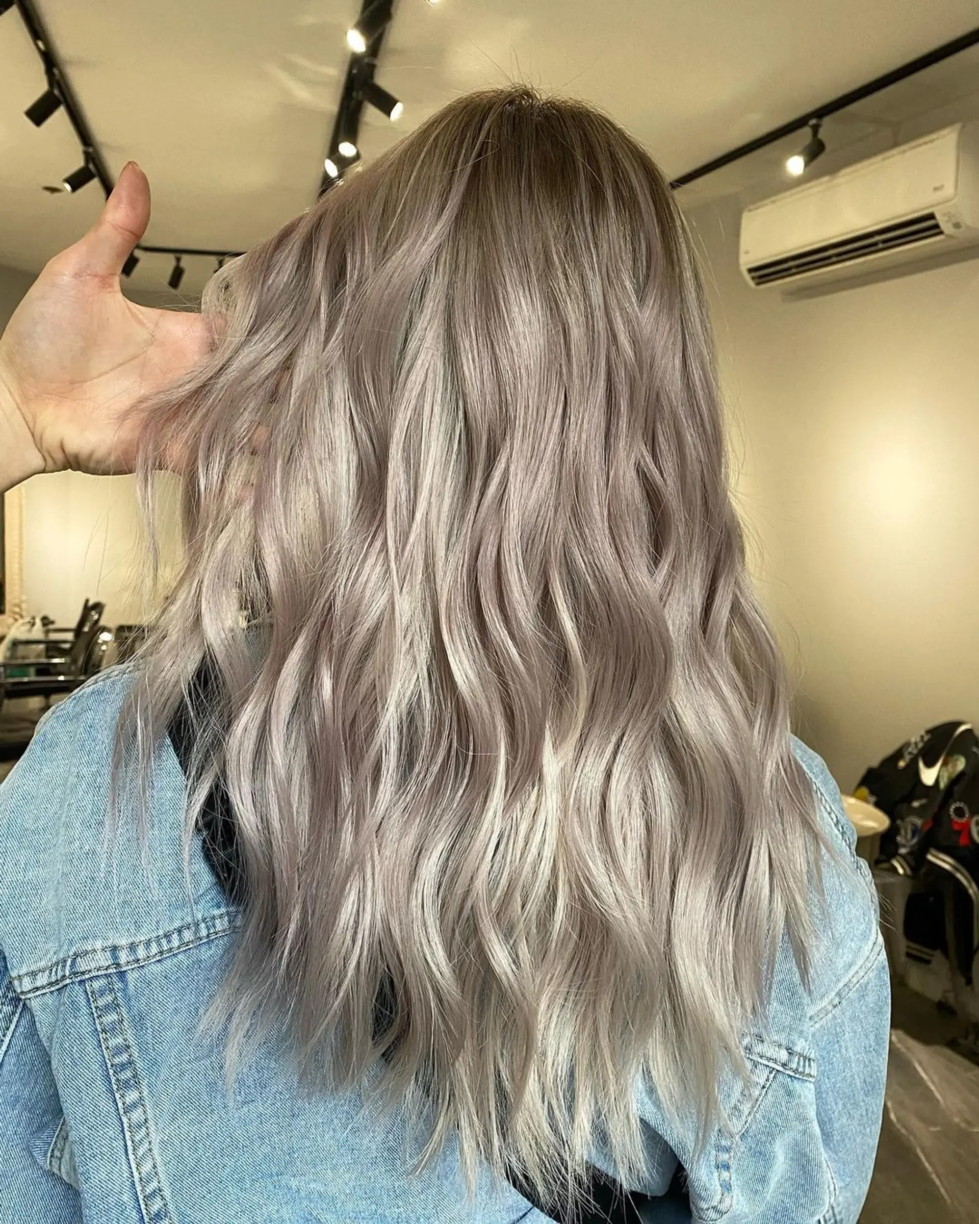 Pastel Lavender and Silver locks cascade down in long, wavy layers, giving a soft, ethereal look with rich waves and gently blended bangs. 2