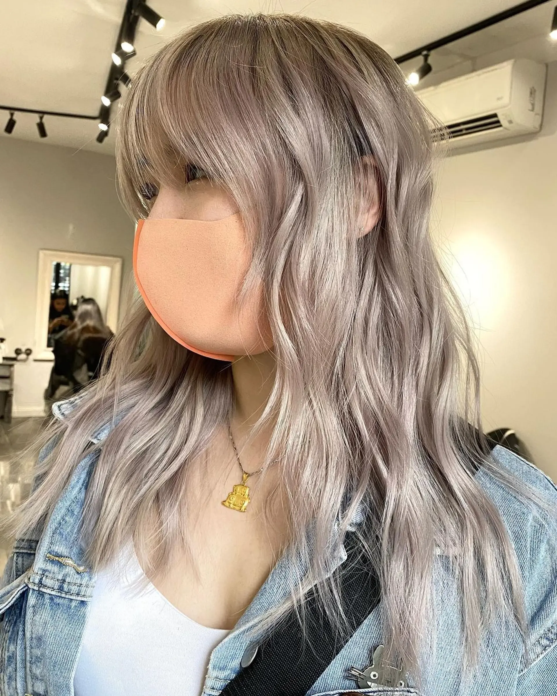Pastel Lavender and Silver locks cascade down in long, wavy layers, giving a soft, ethereal look with rich waves and gently blended bangs. 1
