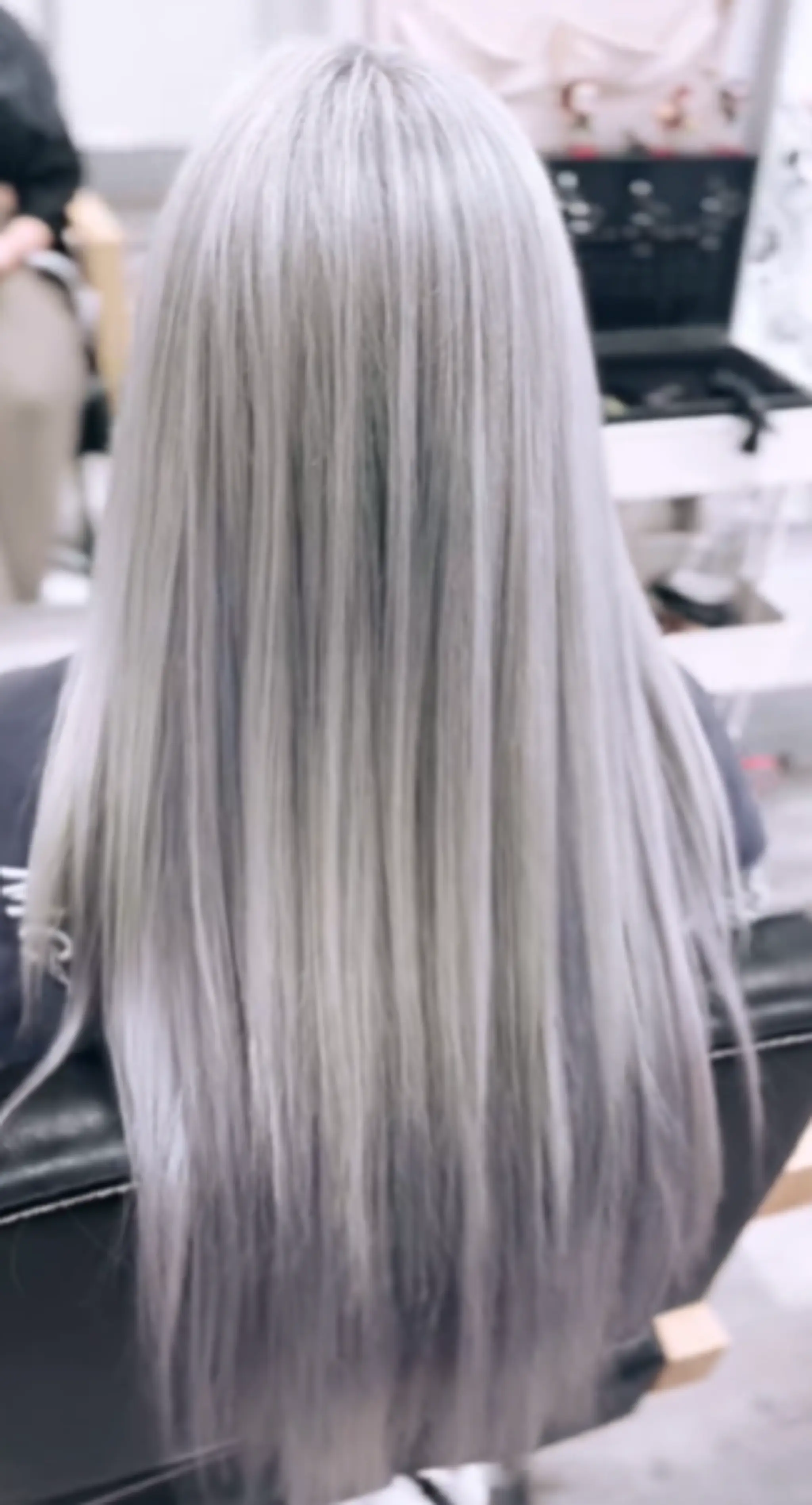 Very long, straight hair with a luxurious silver and platinum color, styled sleek and smooth into a seamless flow.
