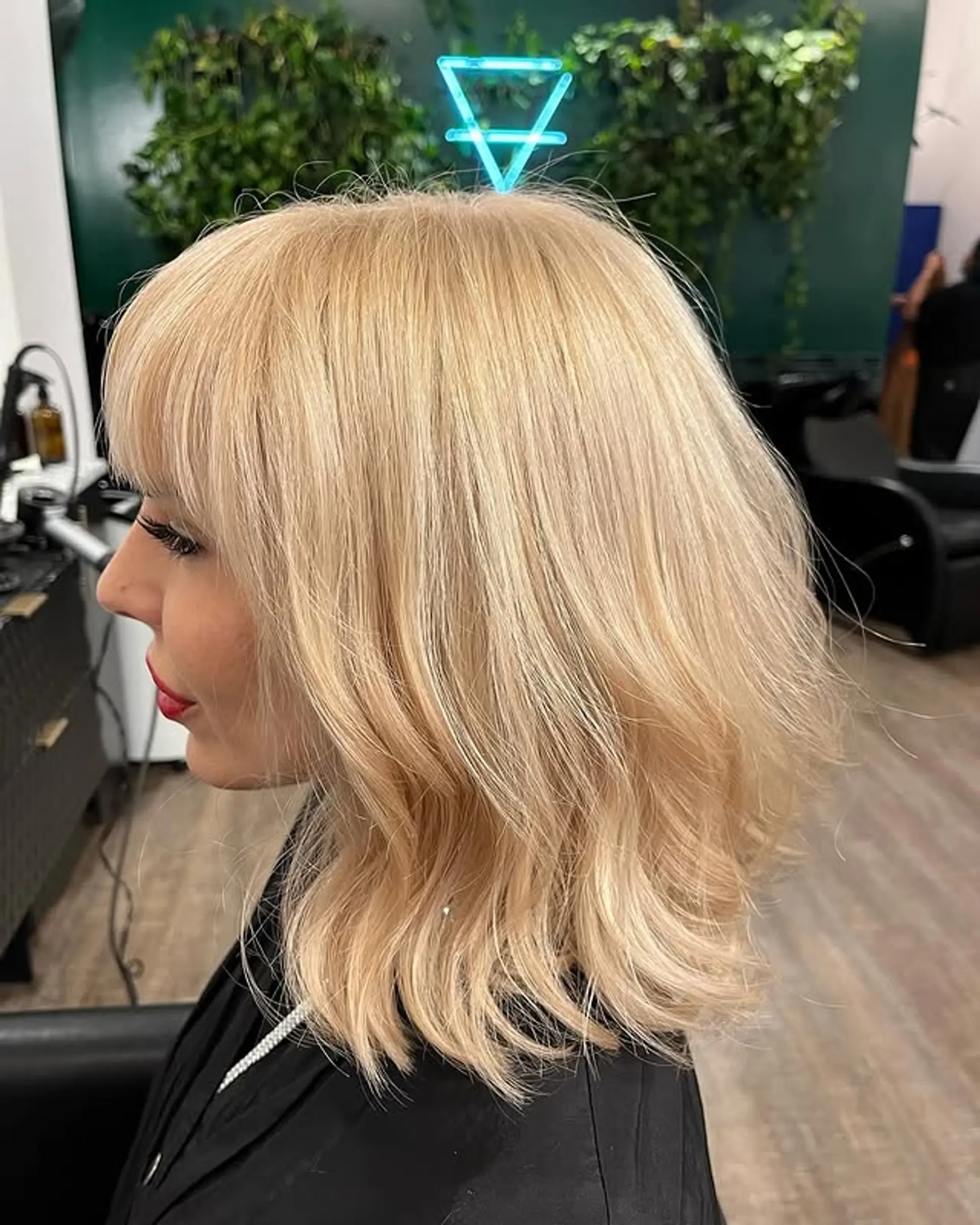 A medium-length wavy bob with blunt bangs and textured waves. 1