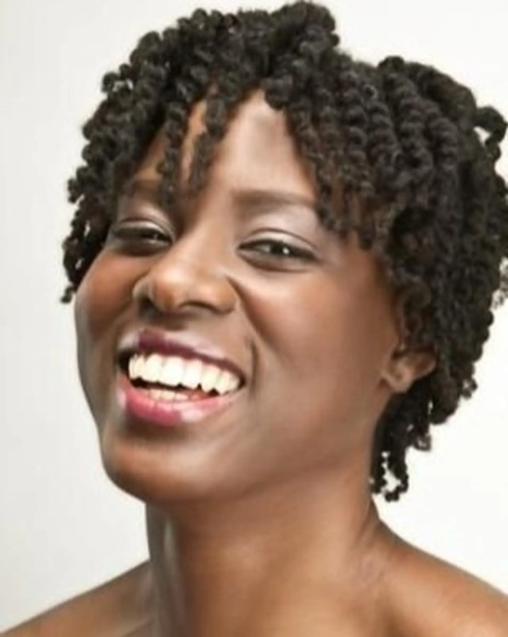 A short twist out hairstyle with defined coils and a textured finish. 1