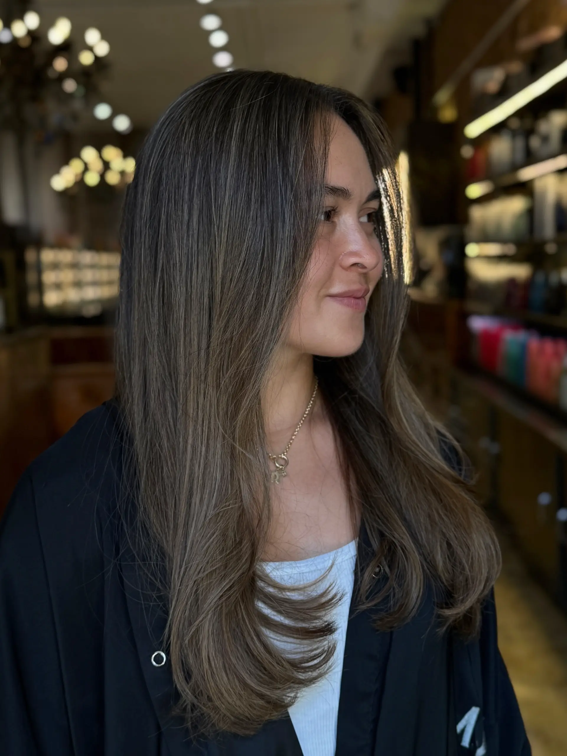 A soft, dimensional mushroom brunette color with a seamless, natural-looking blend. 1