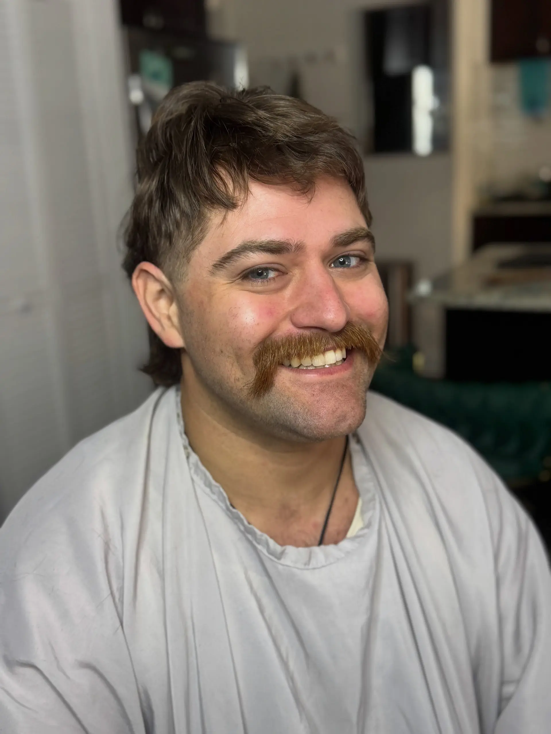 A modern textured mullet featuring a choppy micro fringe, short tapered sides, and longer layered length in the back. 1
