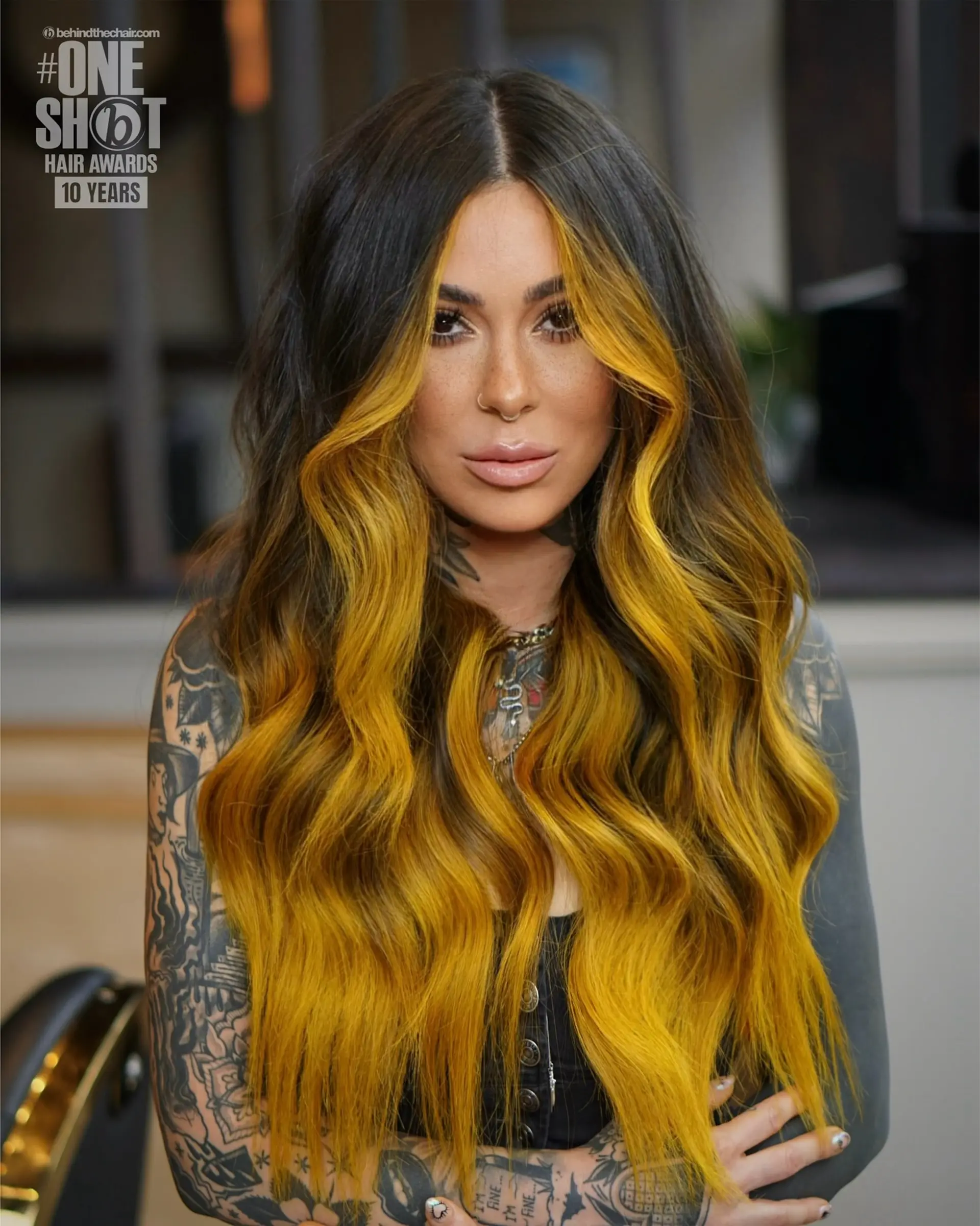 Long dark brown waves highlighted with a bold mustard-yellow face frame and blended balayage. 1