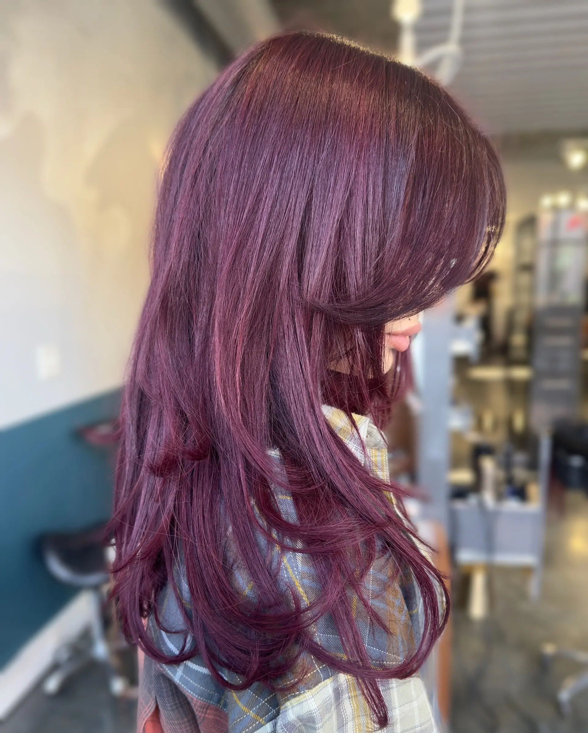 Long, straight layered haircut with full fringe bangs and face framing layers. 1