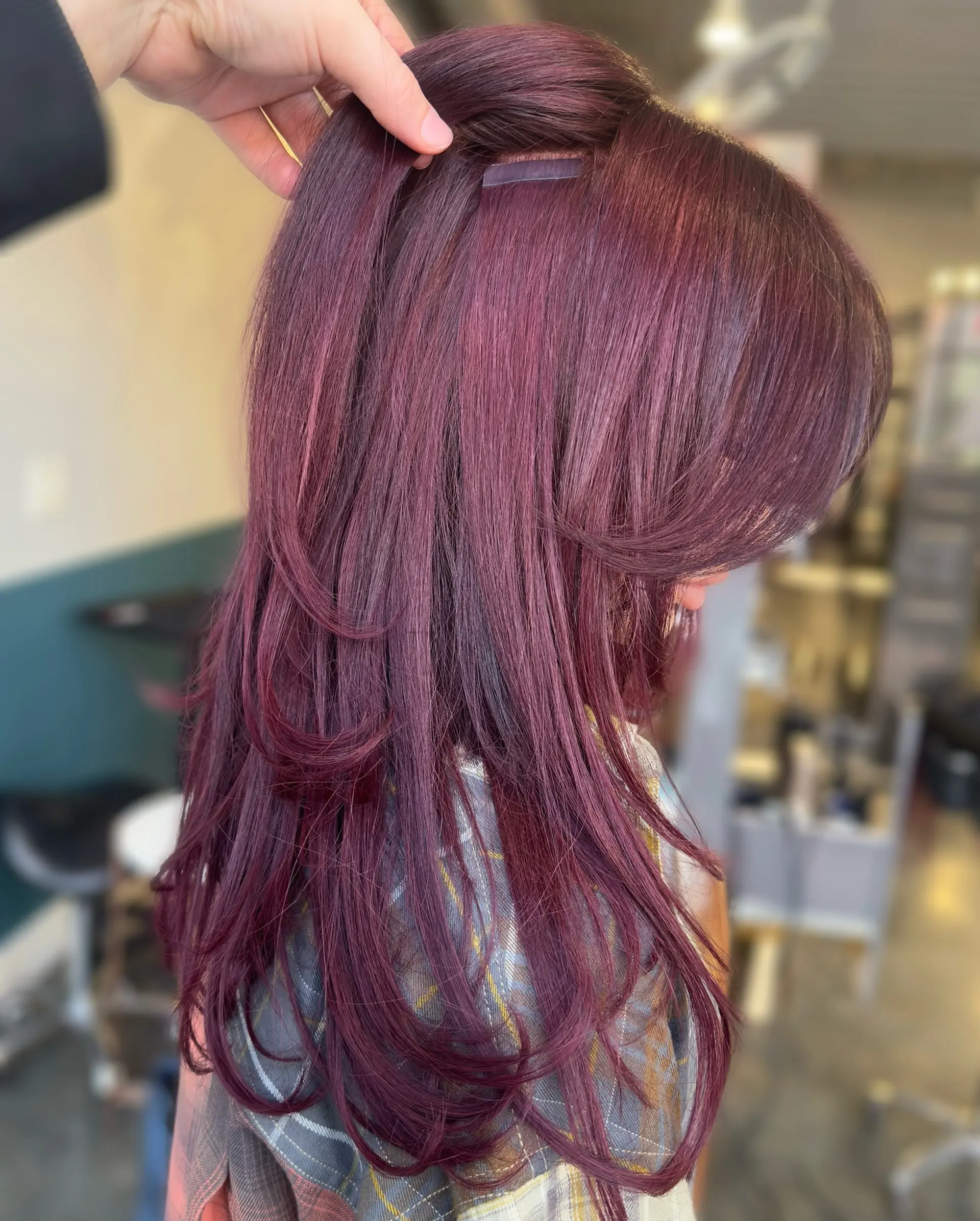 Long, straight layered haircut with full fringe bangs and face framing layers. 2