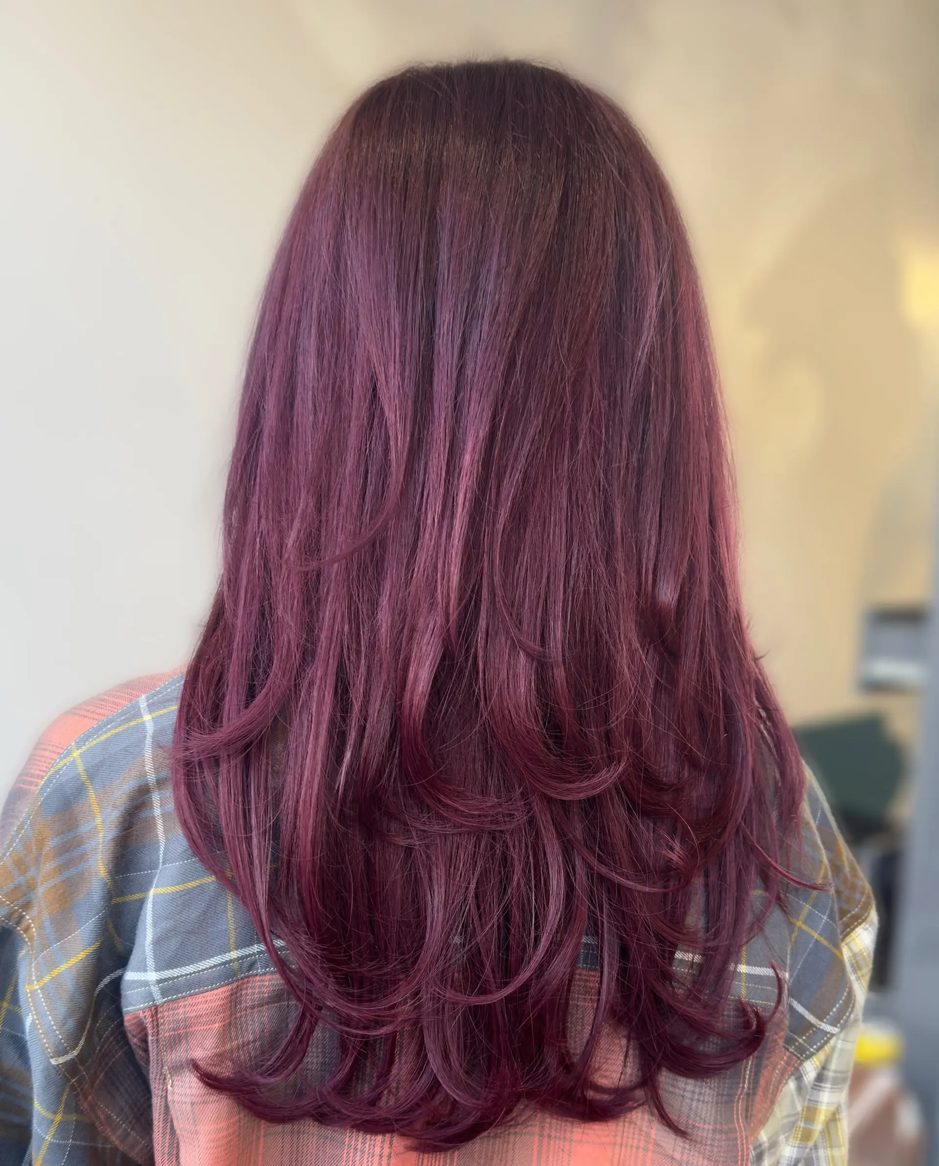 Long, straight layered haircut with full fringe bangs and face framing layers. 3