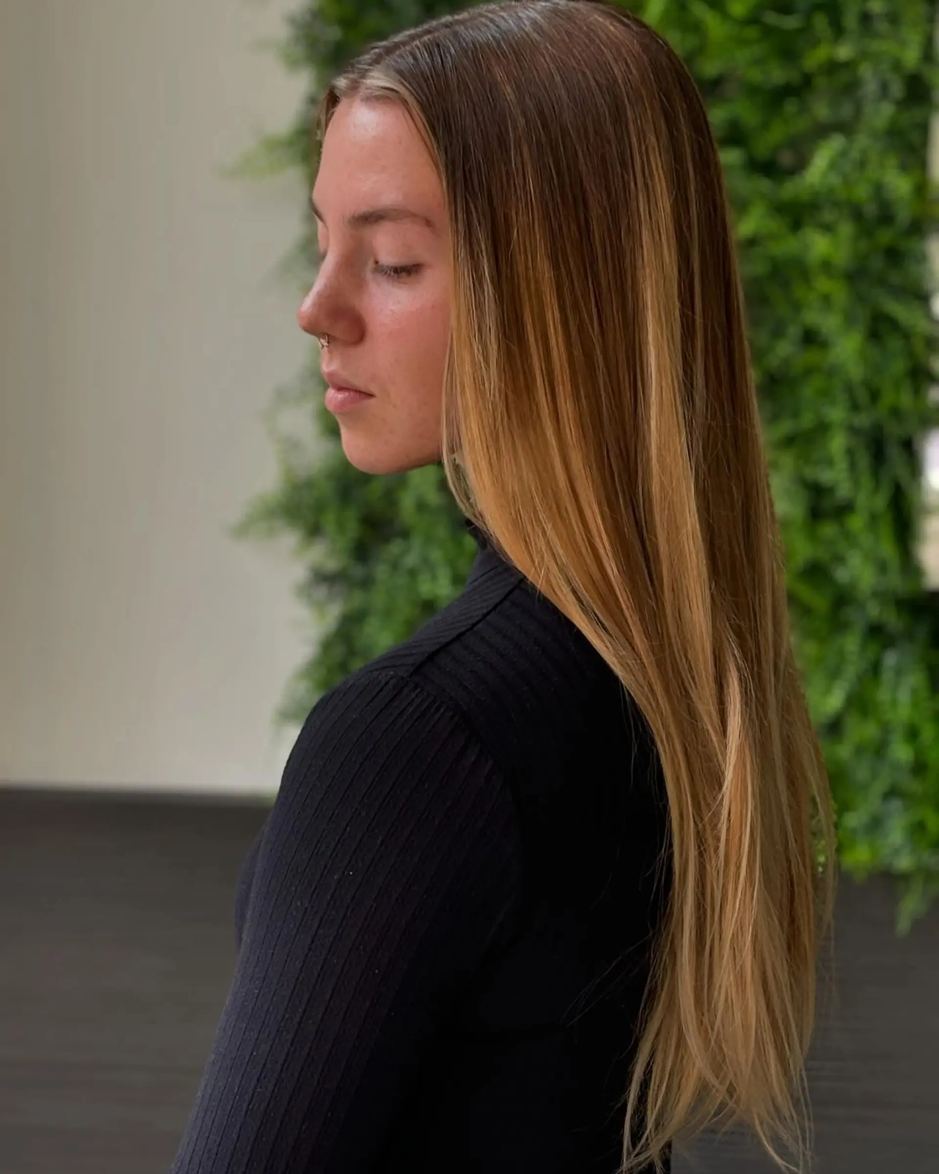 A long, straight hairstyle with a bronzed ombre effect. 1