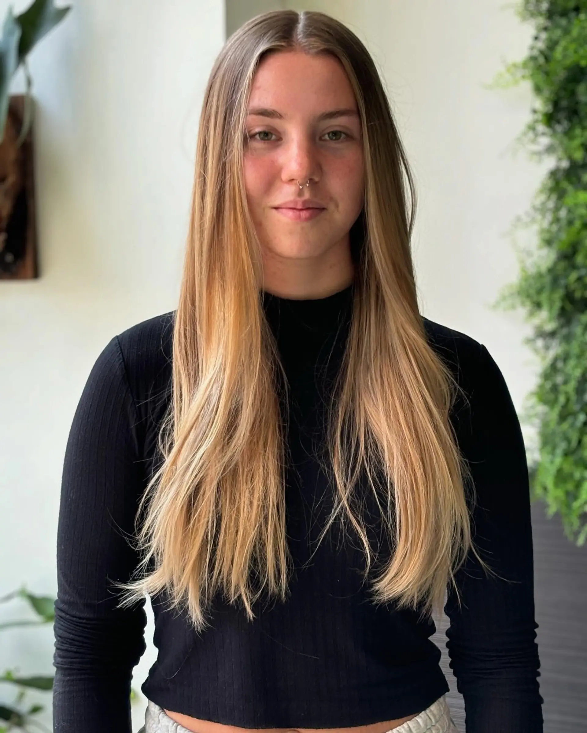 A long, straight hairstyle with a bronzed ombre effect. 3