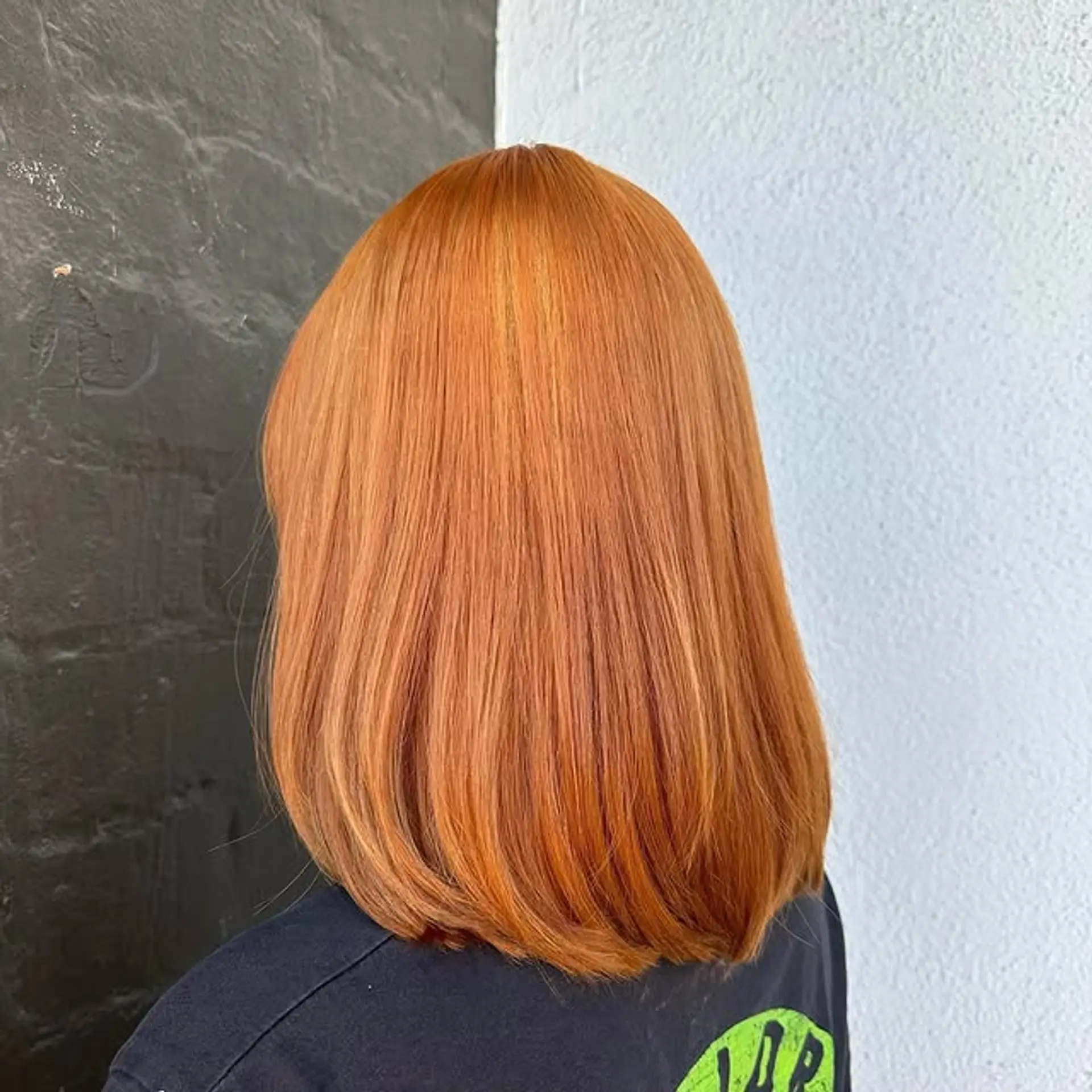 A medium-length blunt bob in a vibrant copper-red color. 1