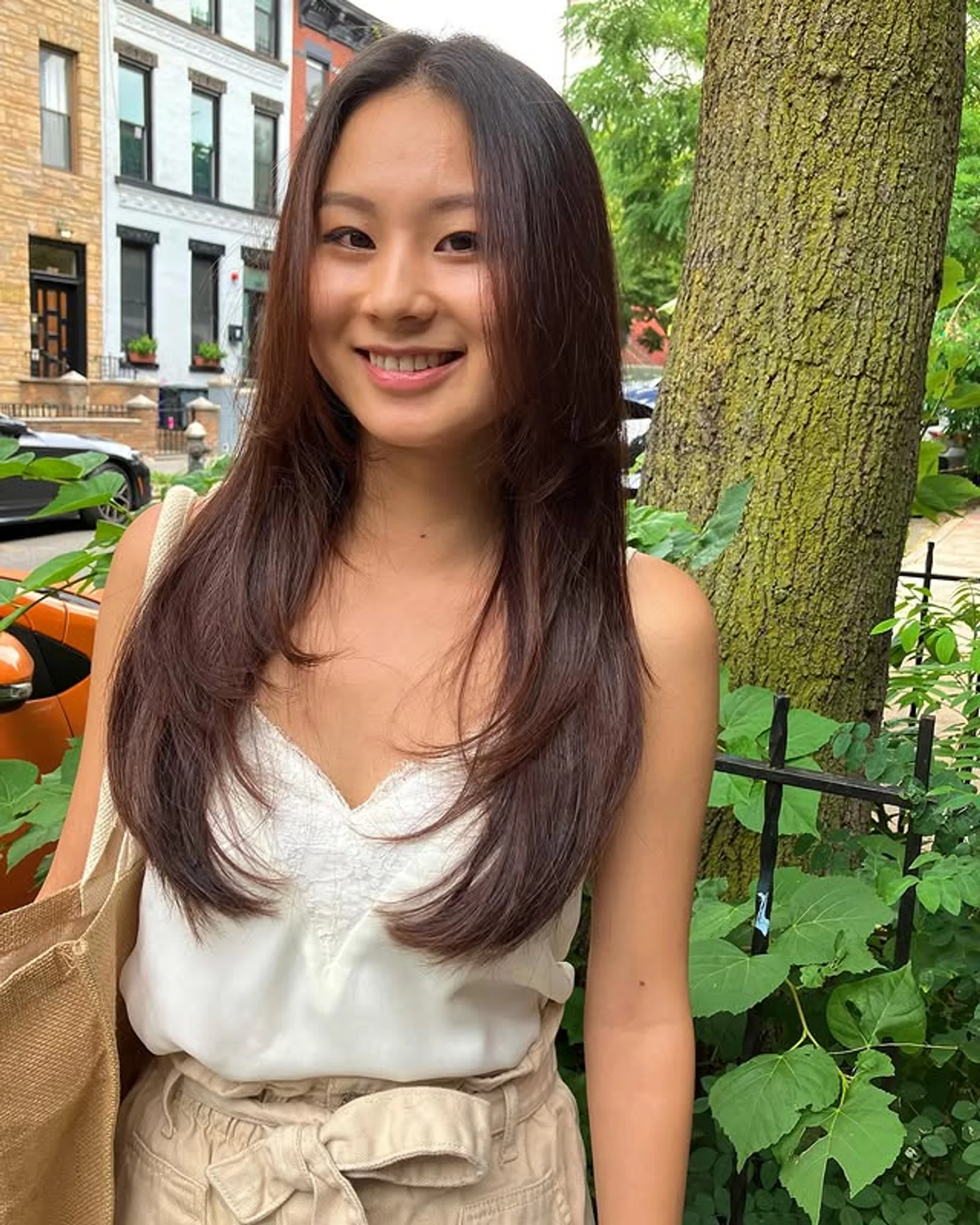 A woman with a modern shag haircut with curtain bangs, showcasing the 2025 Cowgirl Cut trend in NYC. - Preview 3