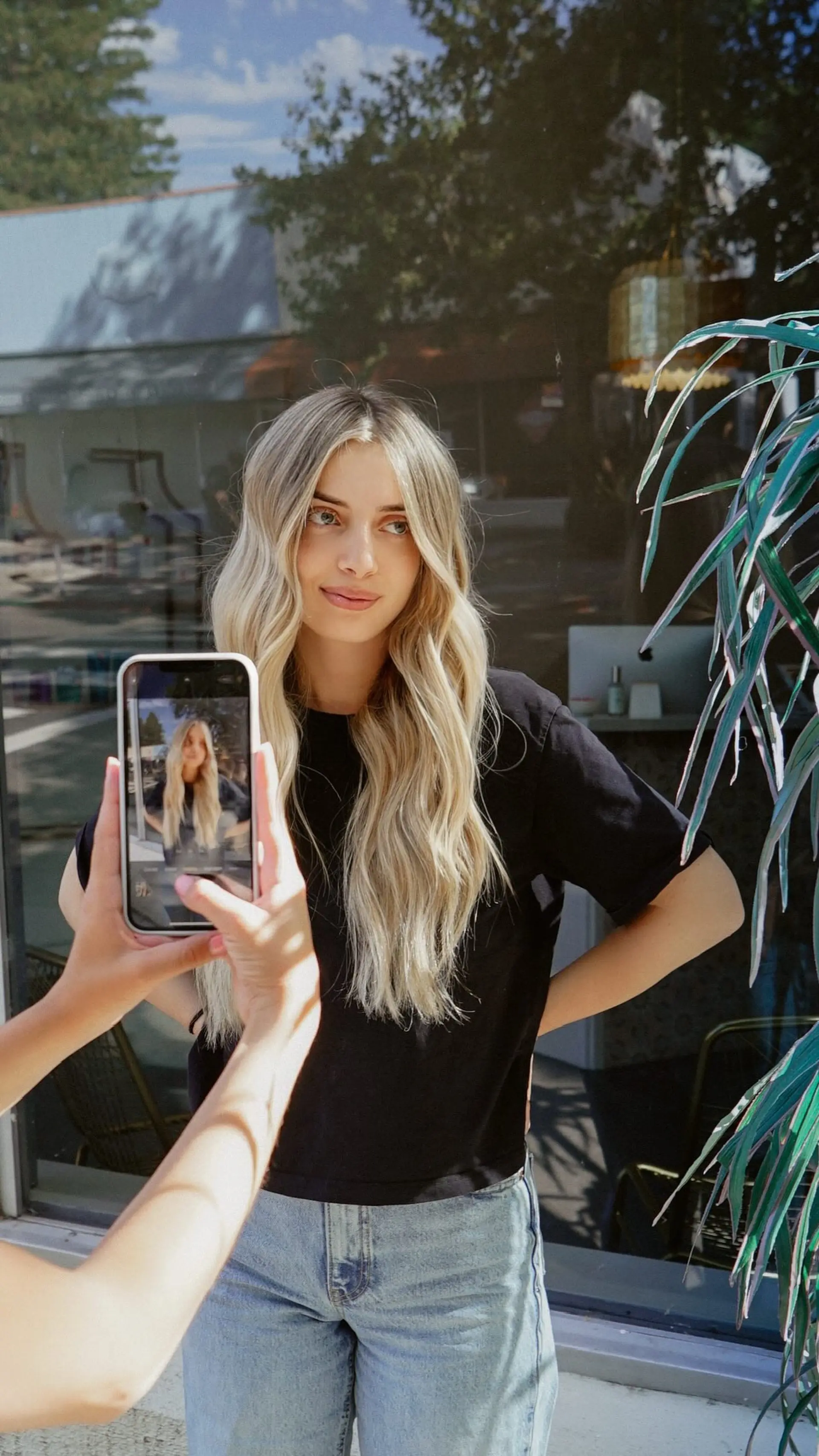 Long dimensional blonde hair styled in soft, undone beach waves with a center part. 1