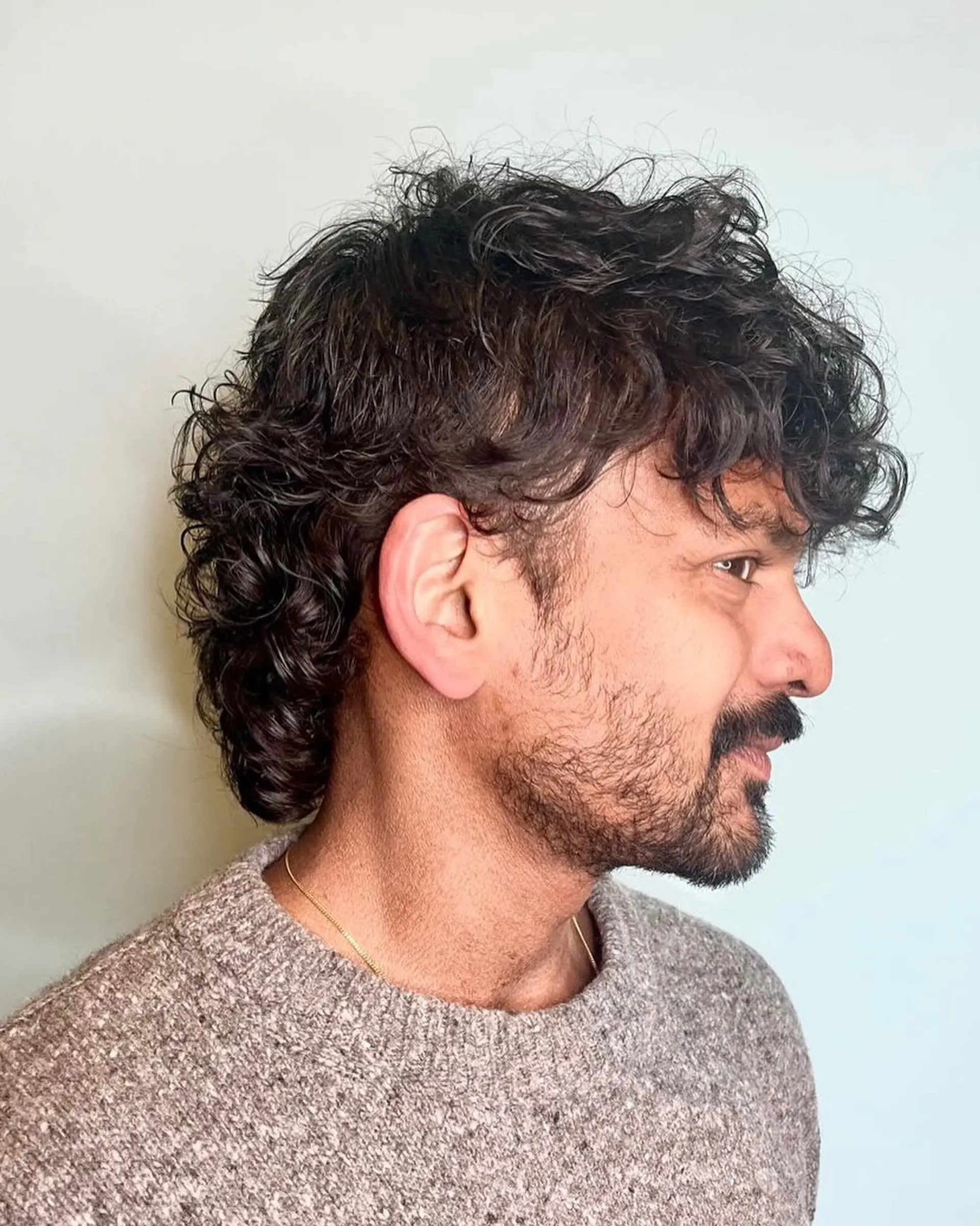 A textured curly crop with a natural fringe and slightly tapered sides. 2