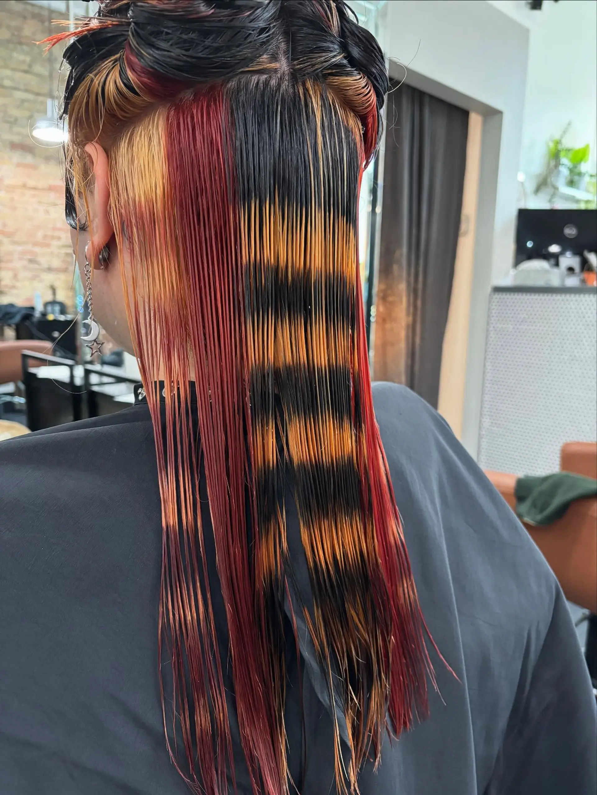 Straight medium-length hair showcasing an alternative calico color design with horizontal raccoon tail stripes in black and orange alongside panels of red and blonde. 1