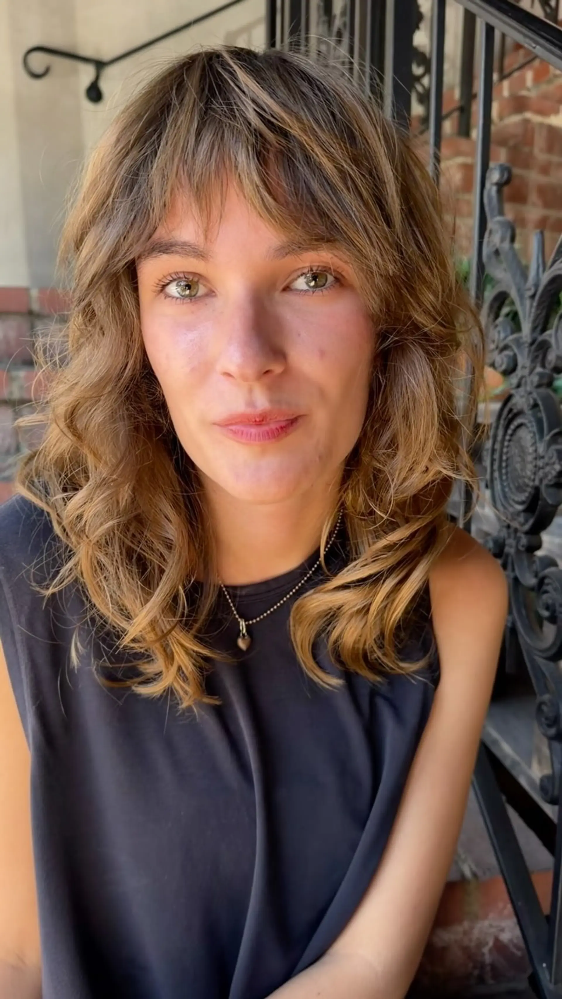 A textured shag haircut featuring wispy bangs and face-framing wavy layers. 1