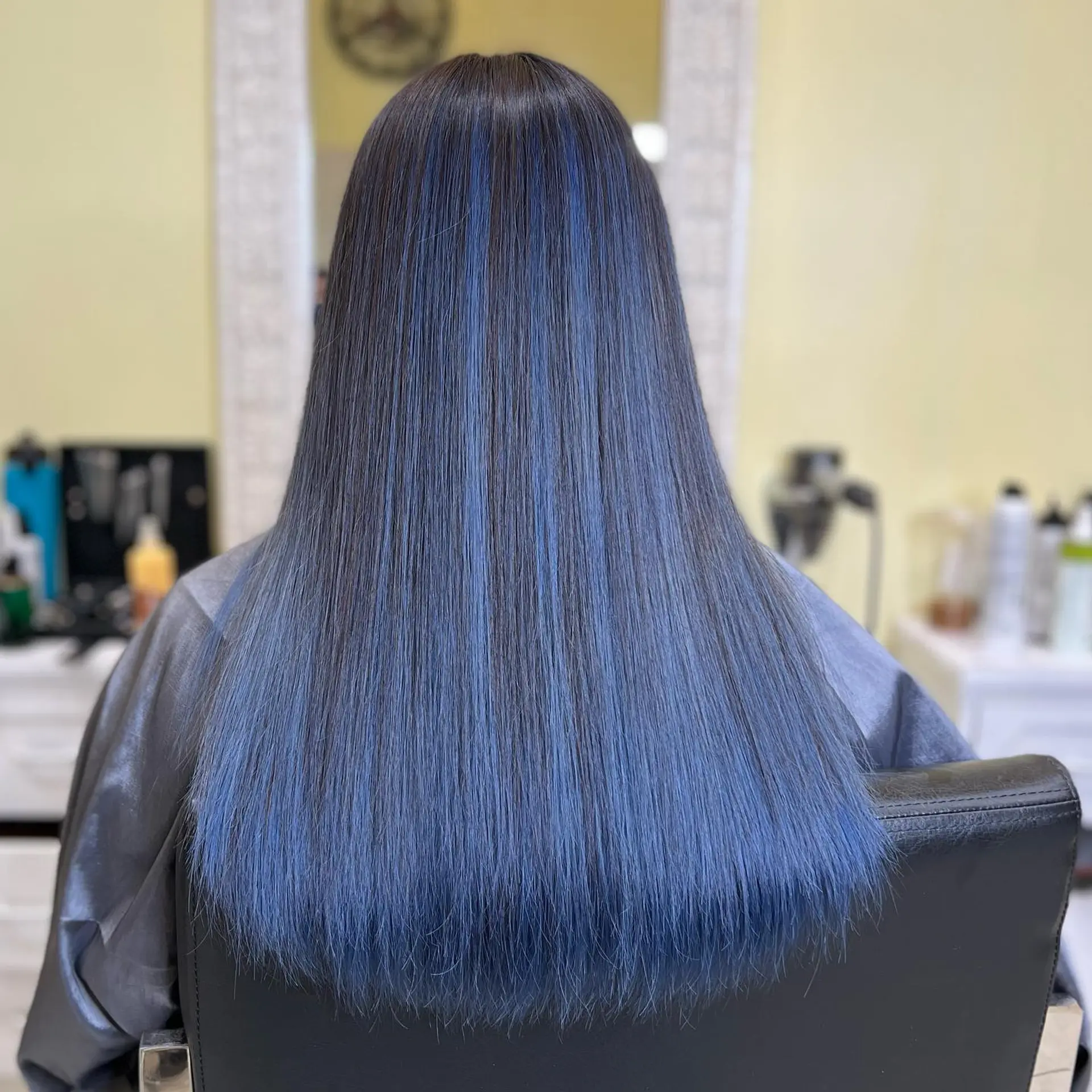 Long, straight hair with bold blue highlights. 1