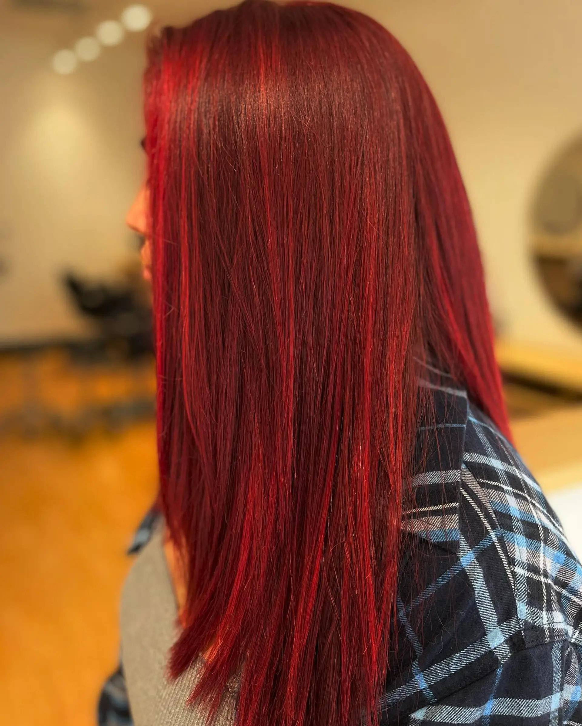 A vibrant, rich crimson red hair color styled sleek and straight. 1