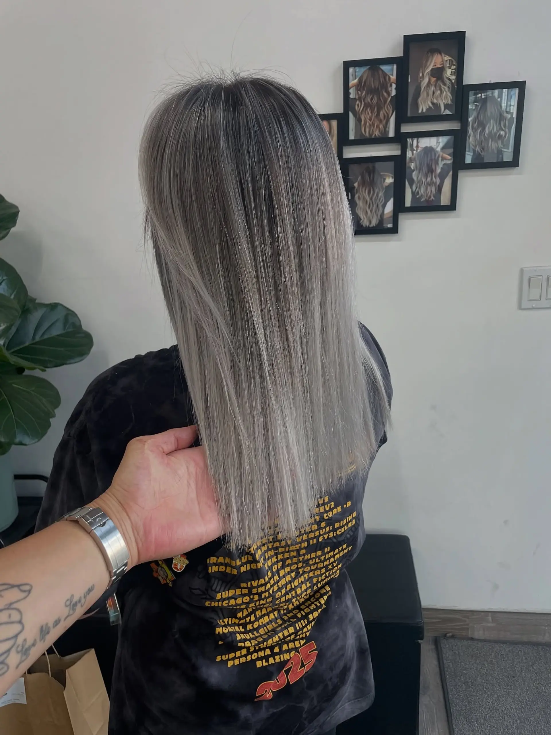 Sleek, straight long bob with a trendy silver-gray color and dark roots. 1
