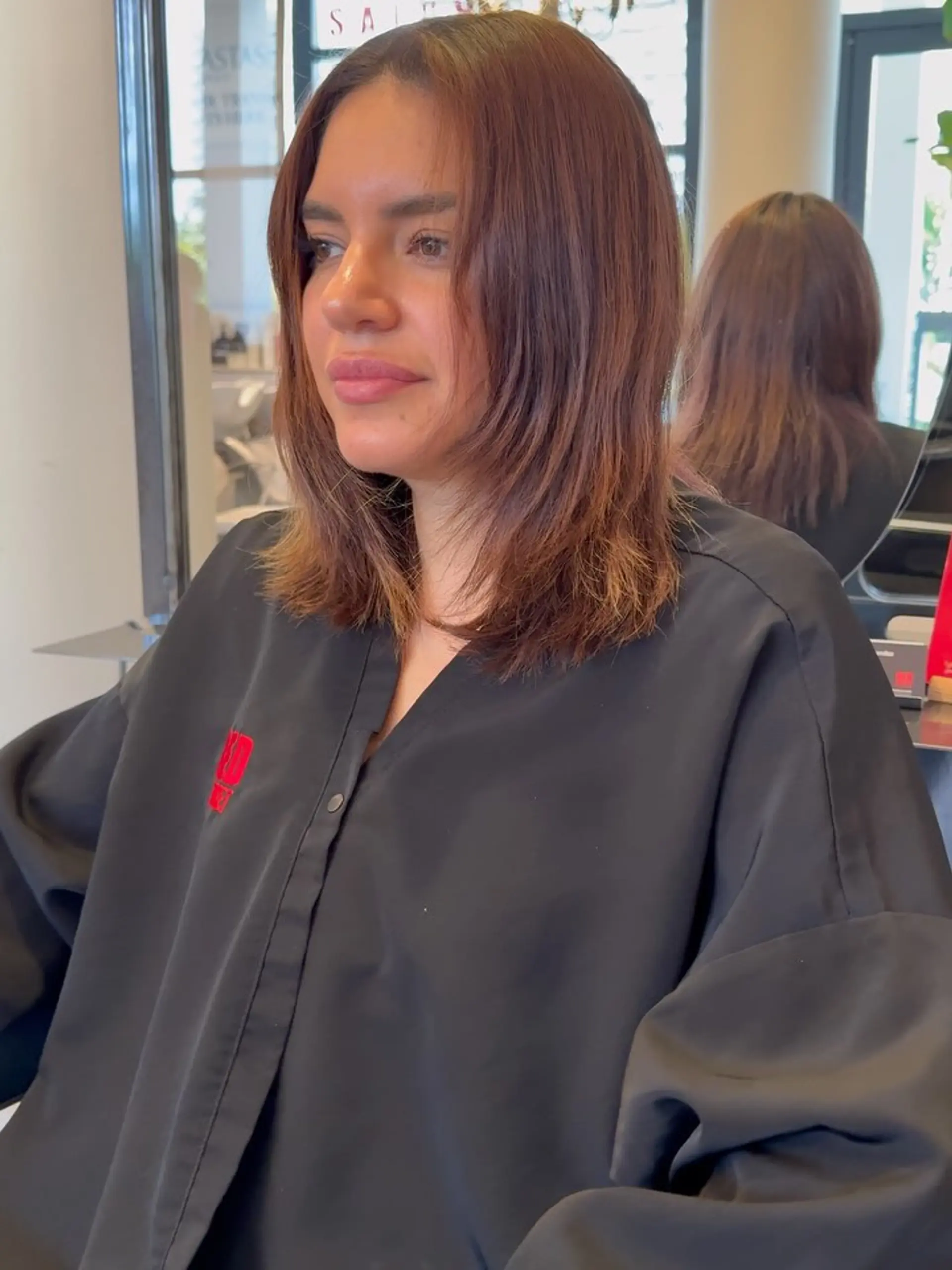 Shoulder-length layered lob styled straight with textured ends and face-framing layers in a rich chestnut brown with subtle caramel highlights. 1