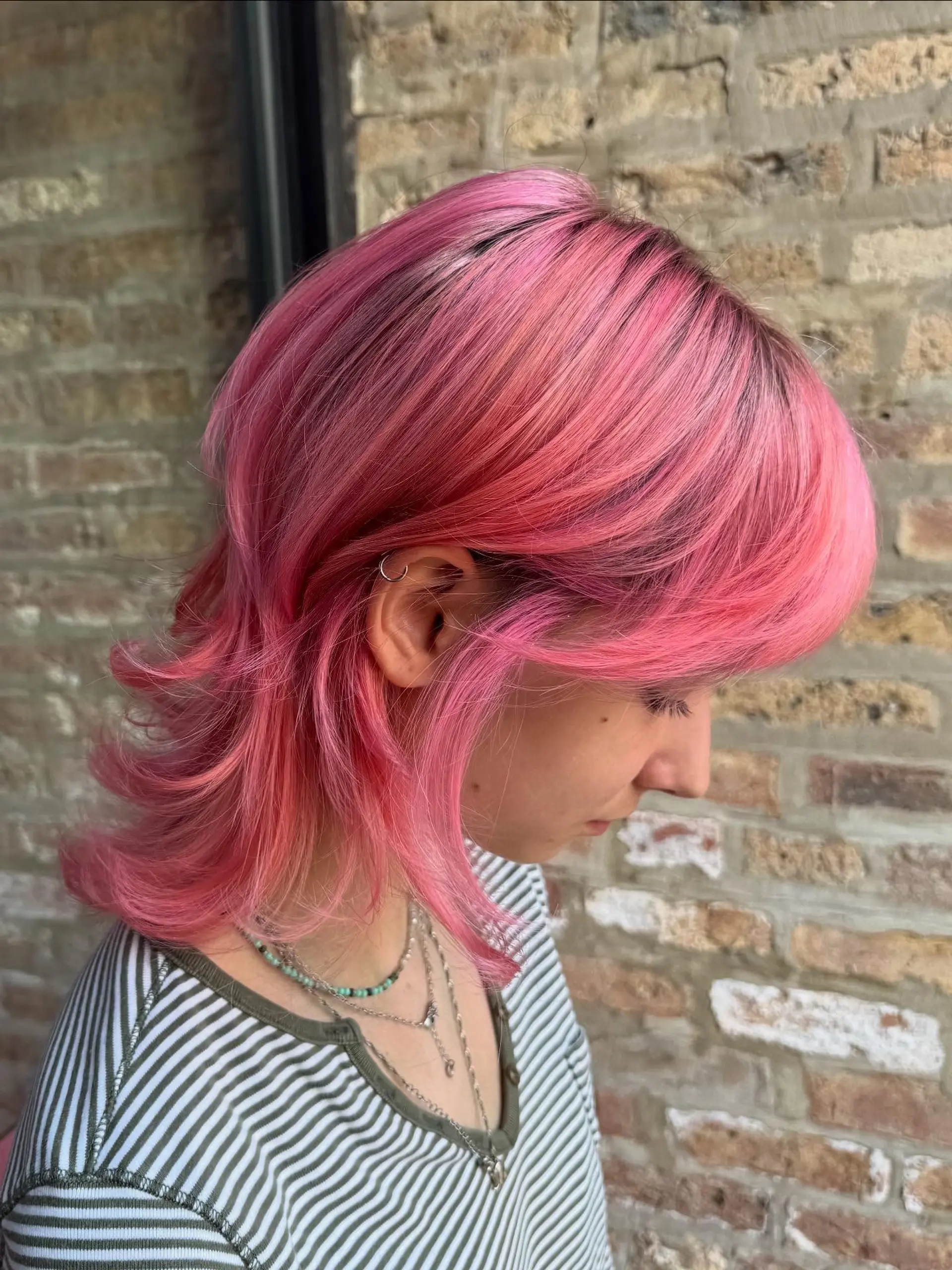 A modern mullet with choppy layers and a bold pink color. 1