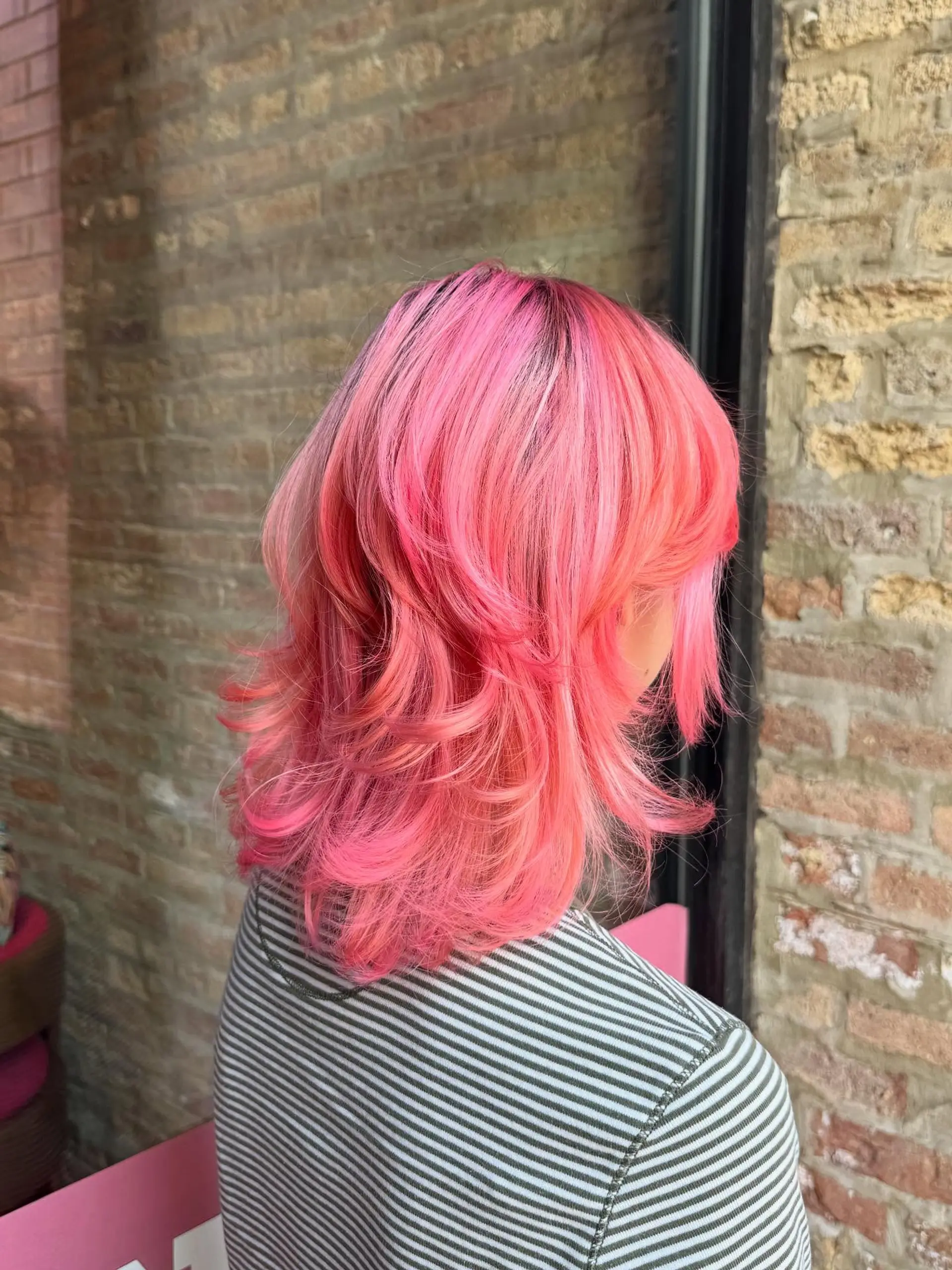 A modern mullet with choppy layers and a bold pink color. 2