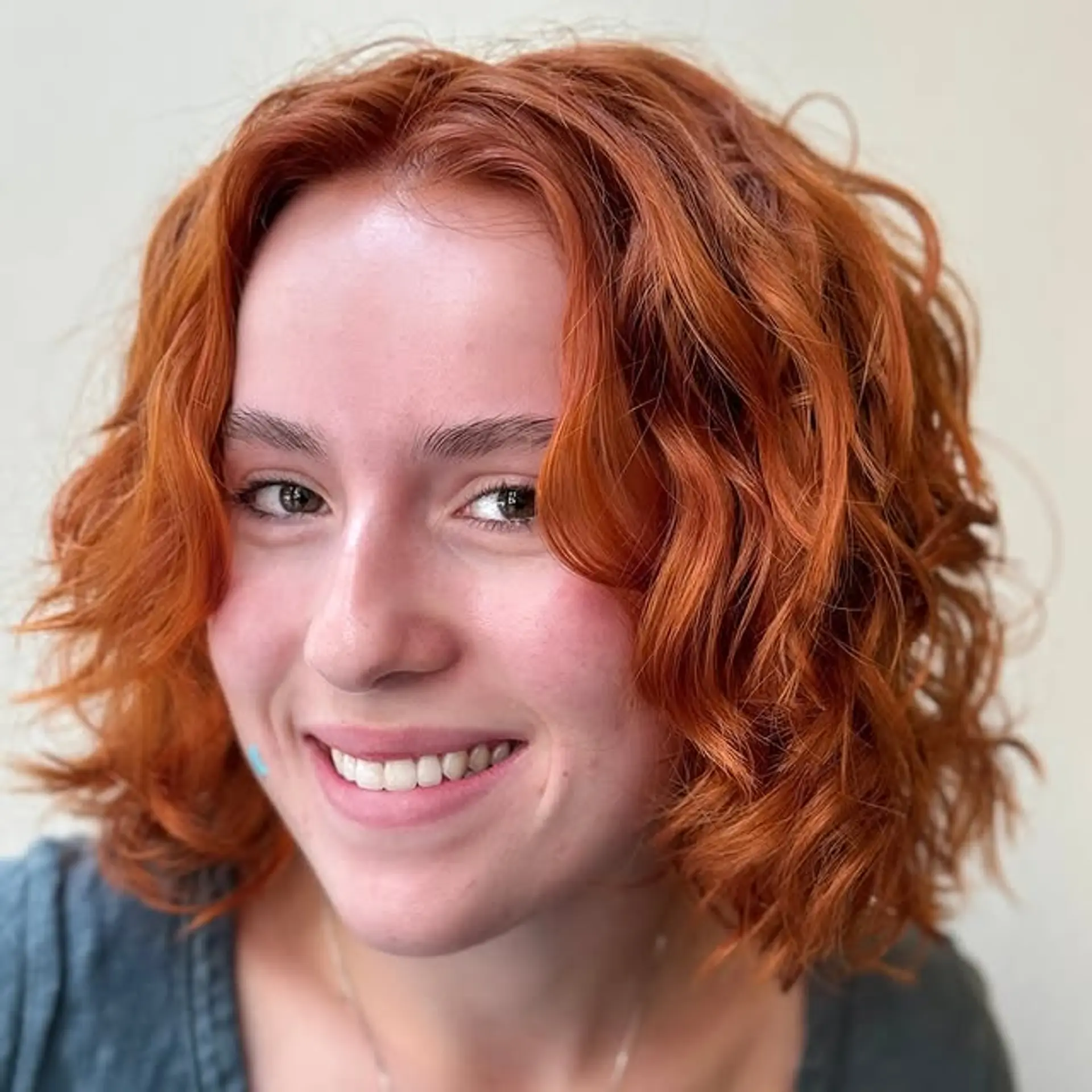 A shaggy bob with choppy layers and modern curtain bangs. The waves create a soft, textured look. 1