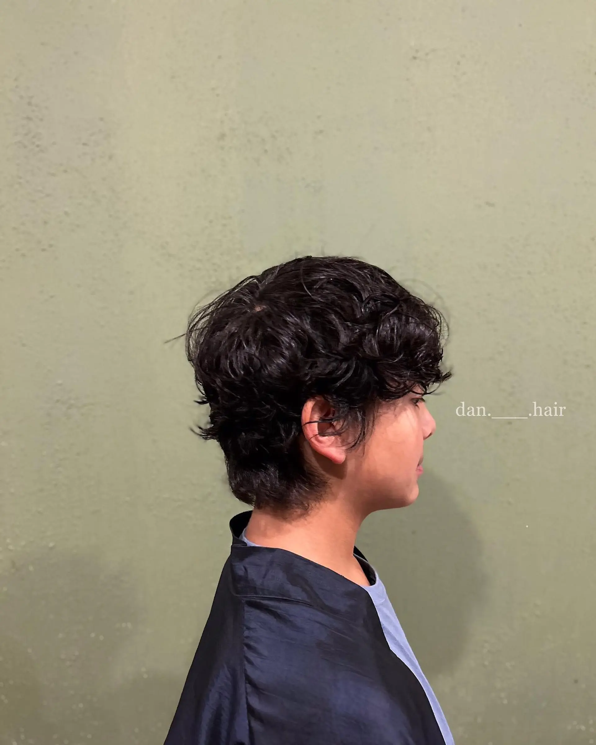 A textured wavy perm styled with soft layers, subtle neck taper, and tousled volume inspired by Korean pop styles. 1