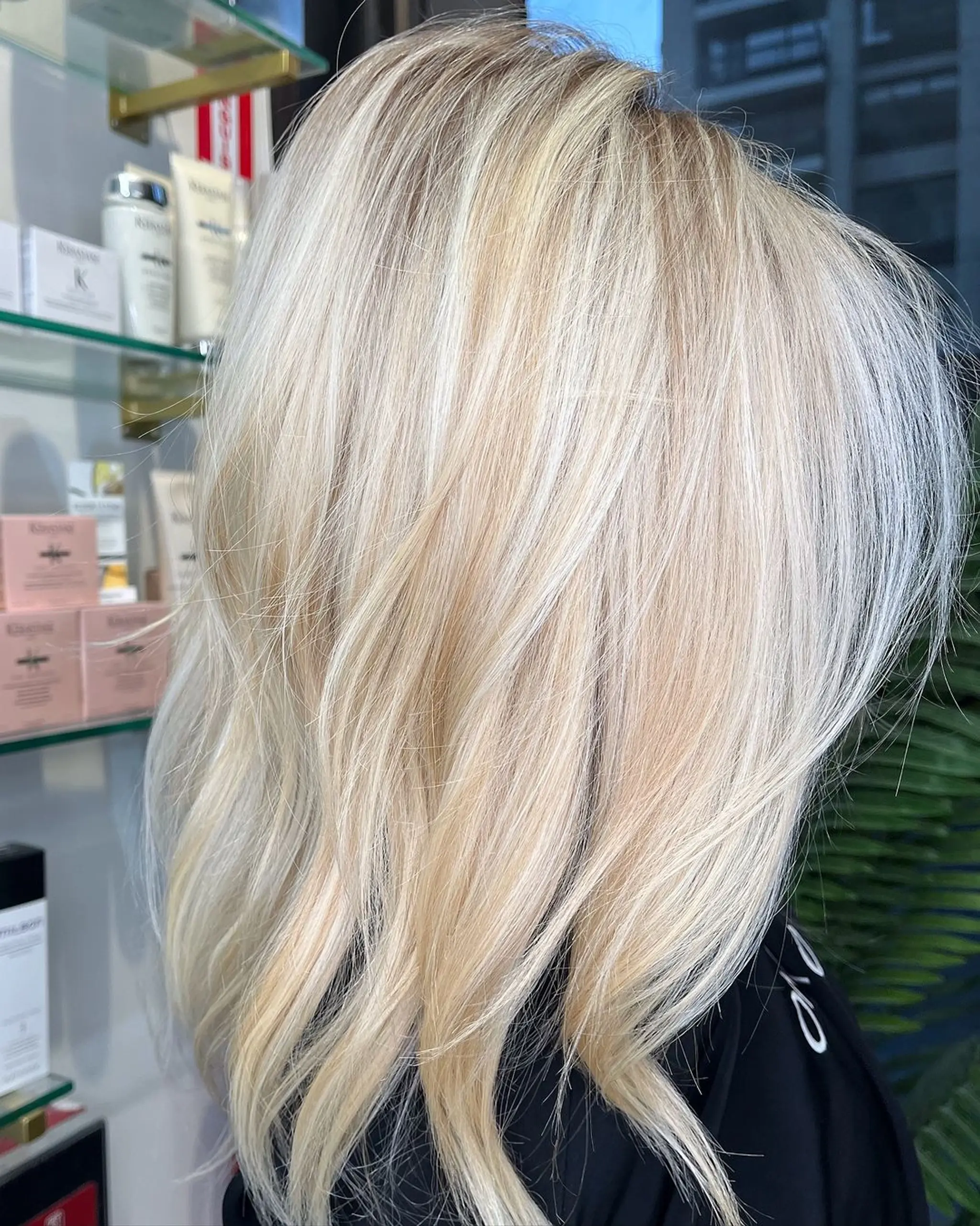 Long, platinum and golden blonde waves with layered, textured, and face-framing elements.