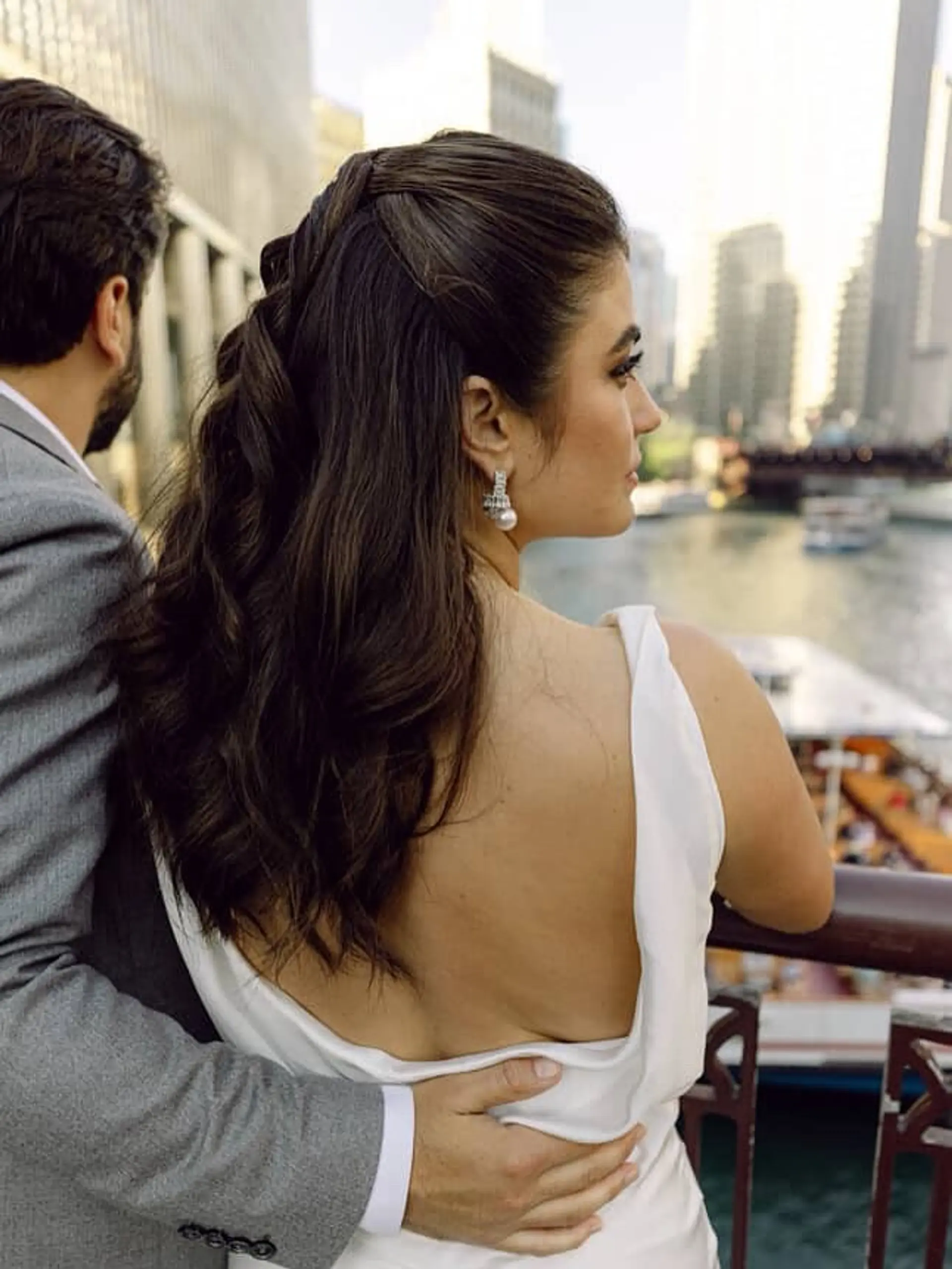 A romantic and elegant half-updo created with twisted sections of hair, cascading into soft waves. 1