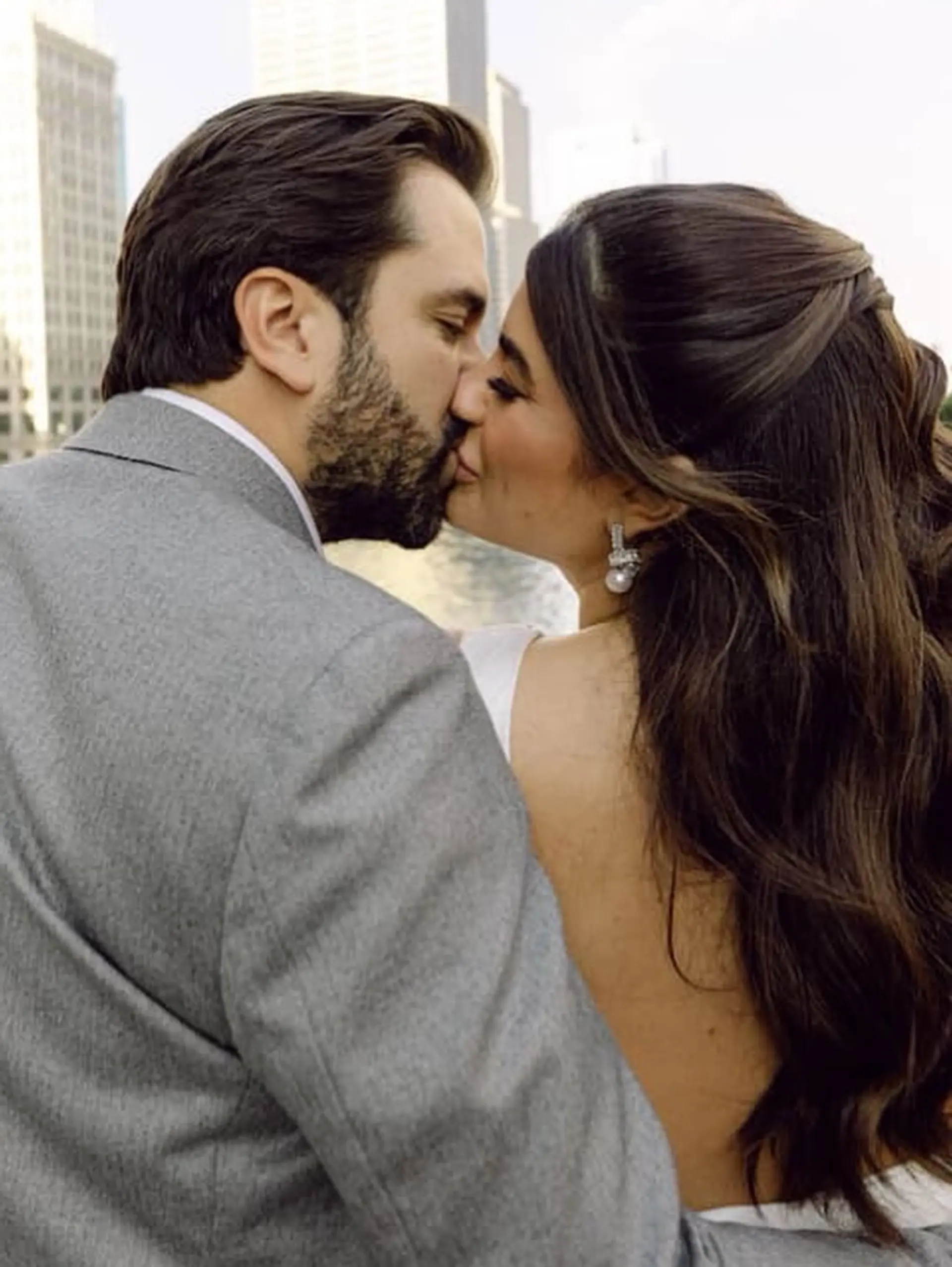 A romantic and elegant half-updo created with twisted sections of hair, cascading into soft waves. 3