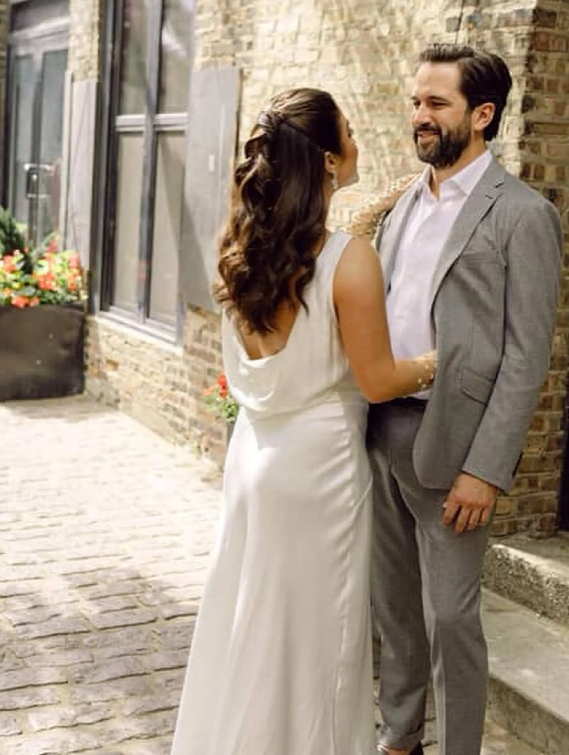 A romantic and elegant half-updo created with twisted sections of hair, cascading into soft waves. 4