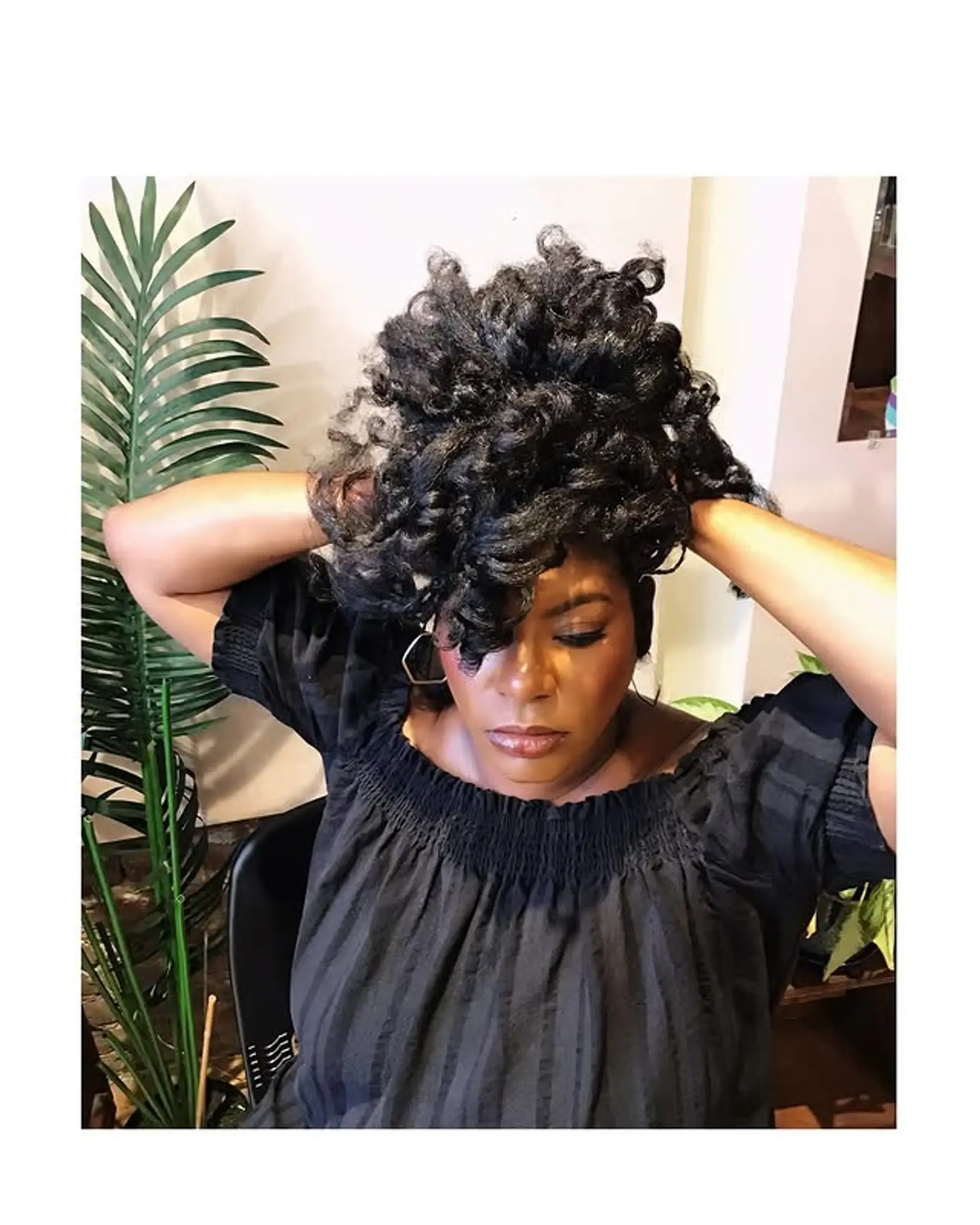 A voluminous curly hairstyle with face-framing layers for added definition. 1