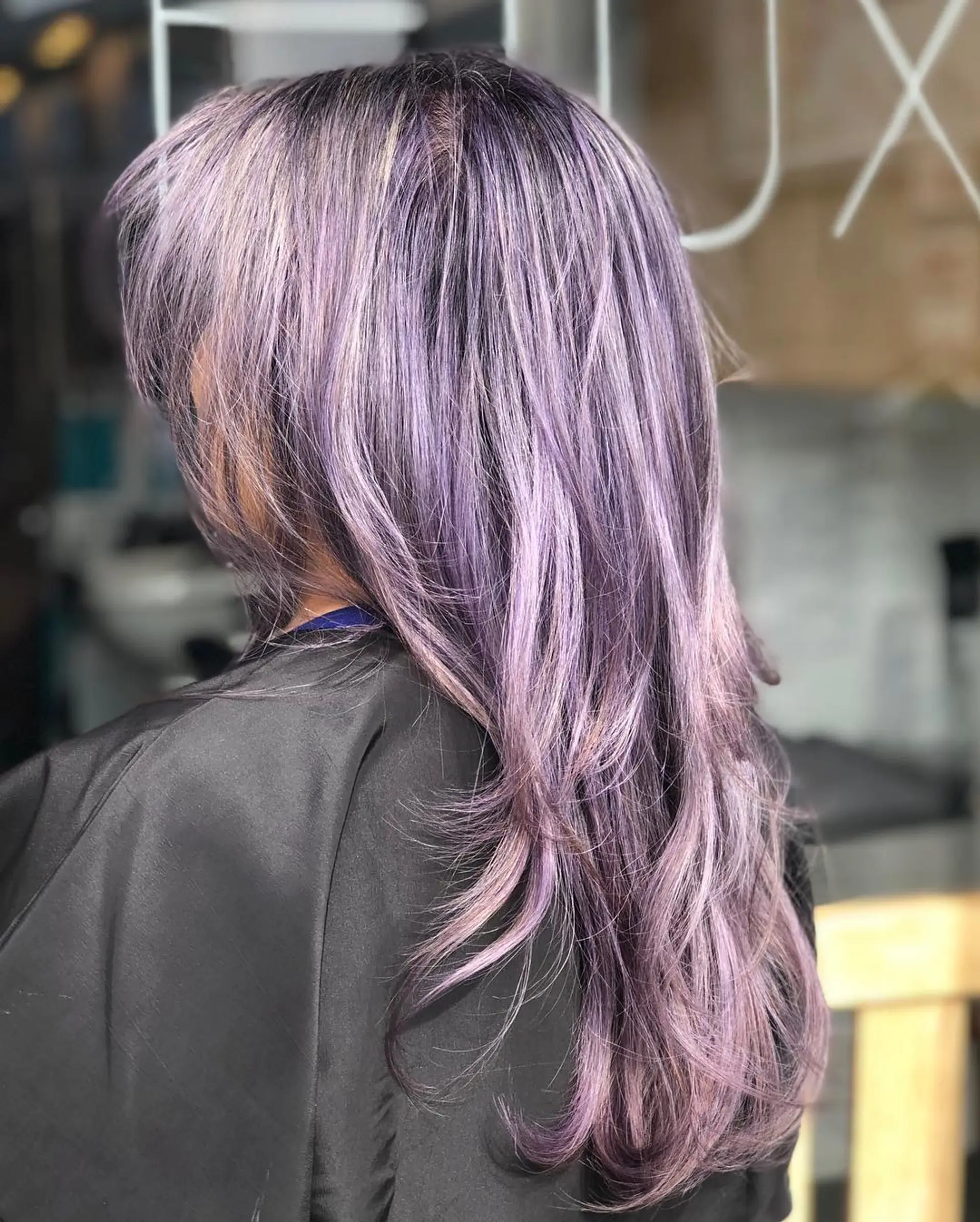 Long layered cut colored in an ethereal silver-lilac tone with soft, feathered texture at the ends. 1