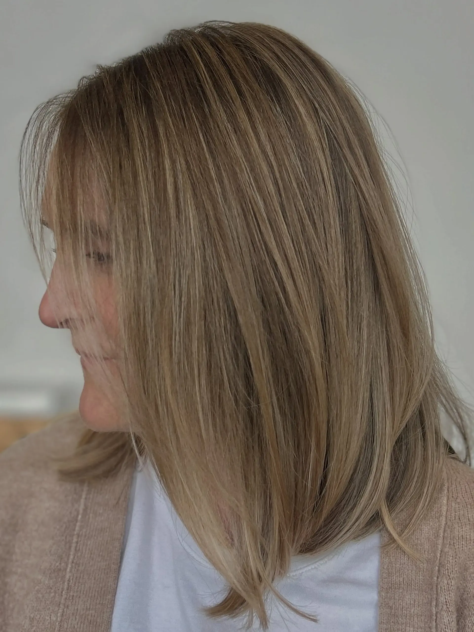 Shoulder-length textured lob featuring fine, dimensional blonde highlights seamlessly blended over a natural light brown base. 1