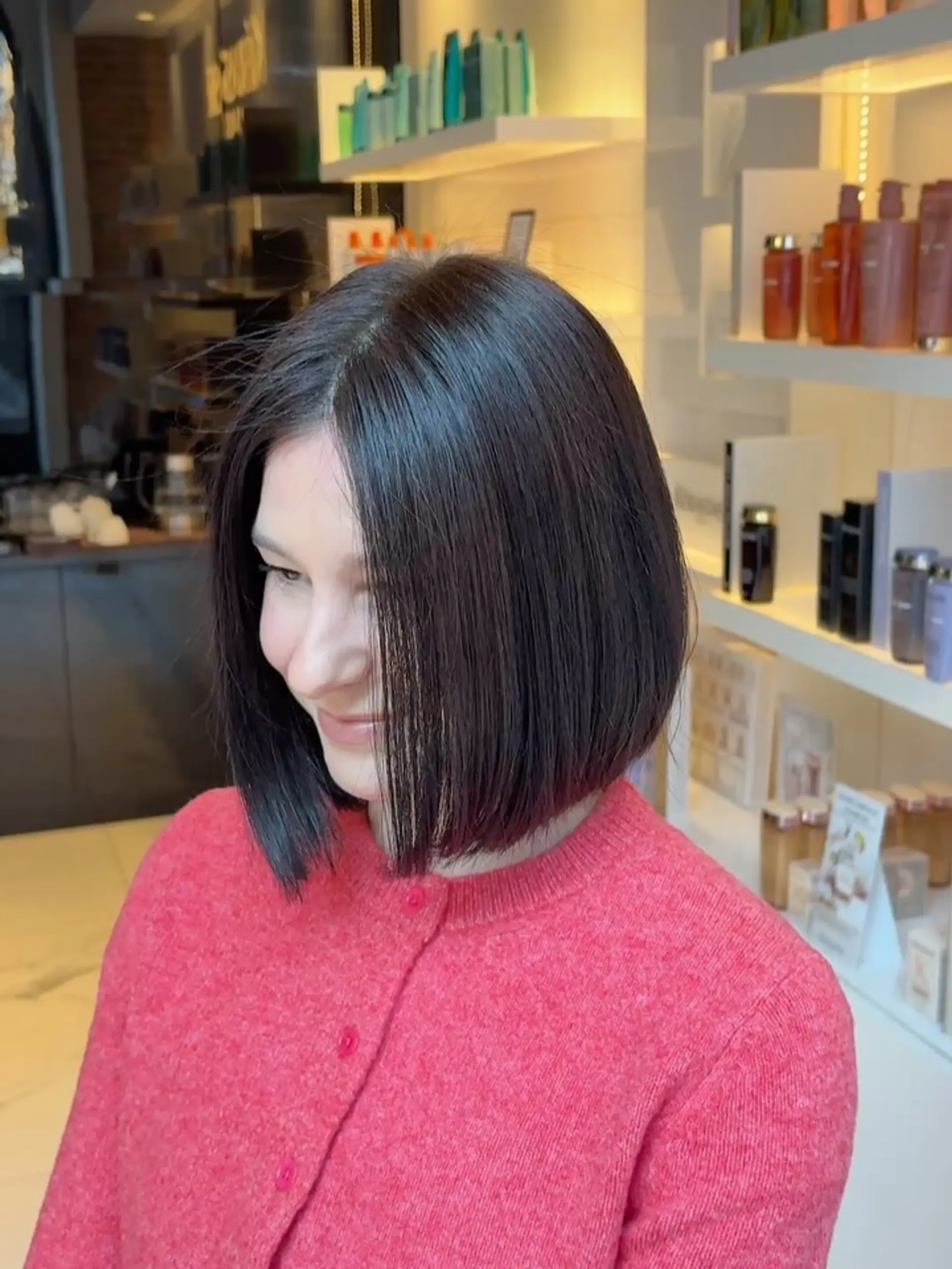 A sleek, chin-length blunt bob styled straight with smooth texture. 1