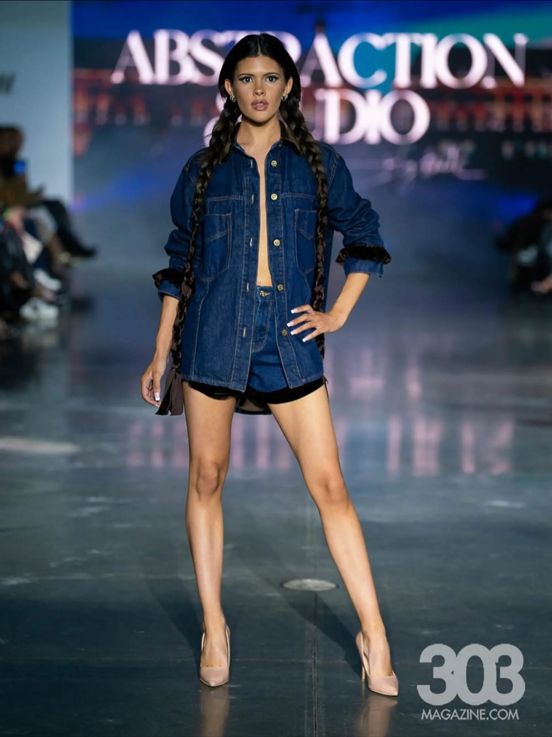 Dramatic ultra-long twin braids styled with a clean center part and sleek crown for a runway look. 1