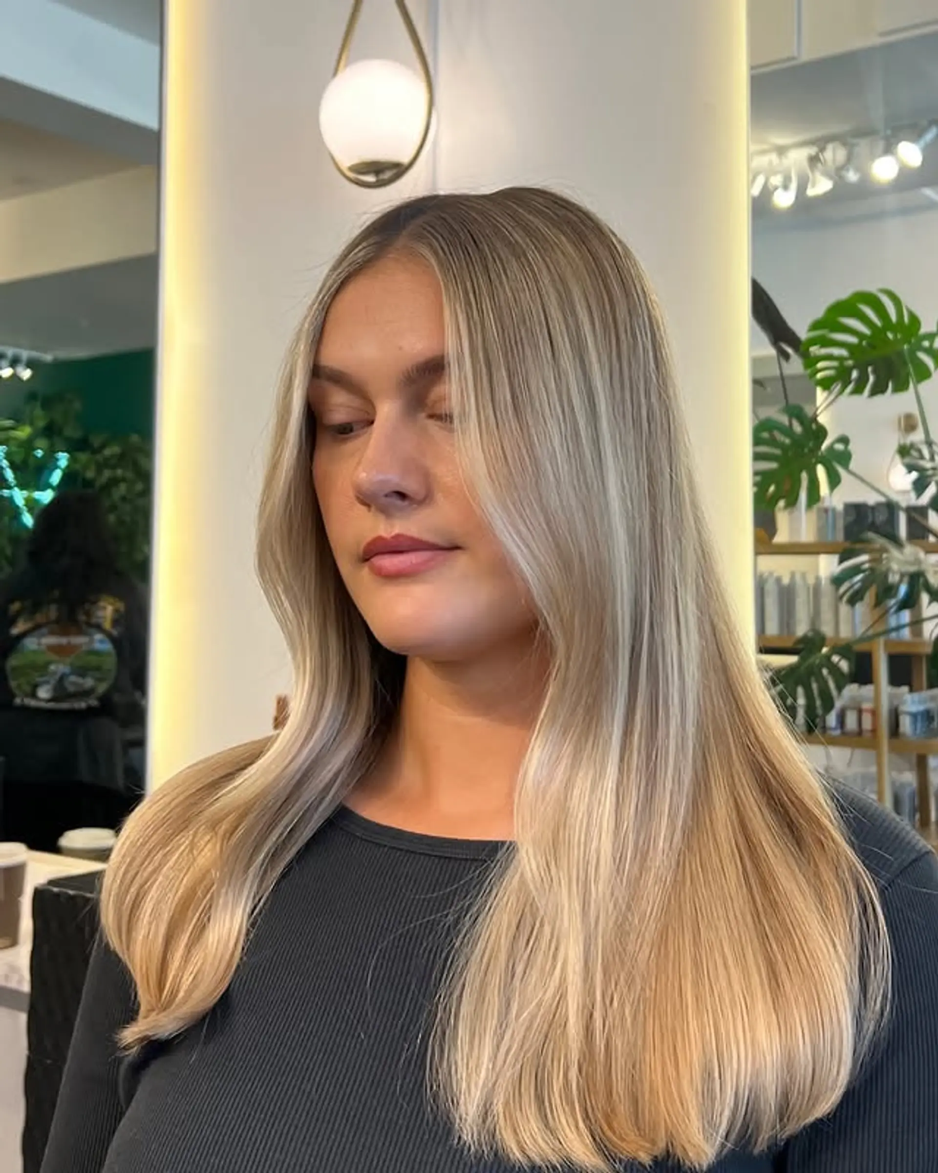 Long, straight hairstyle with a lived-in blonde balayage. 1