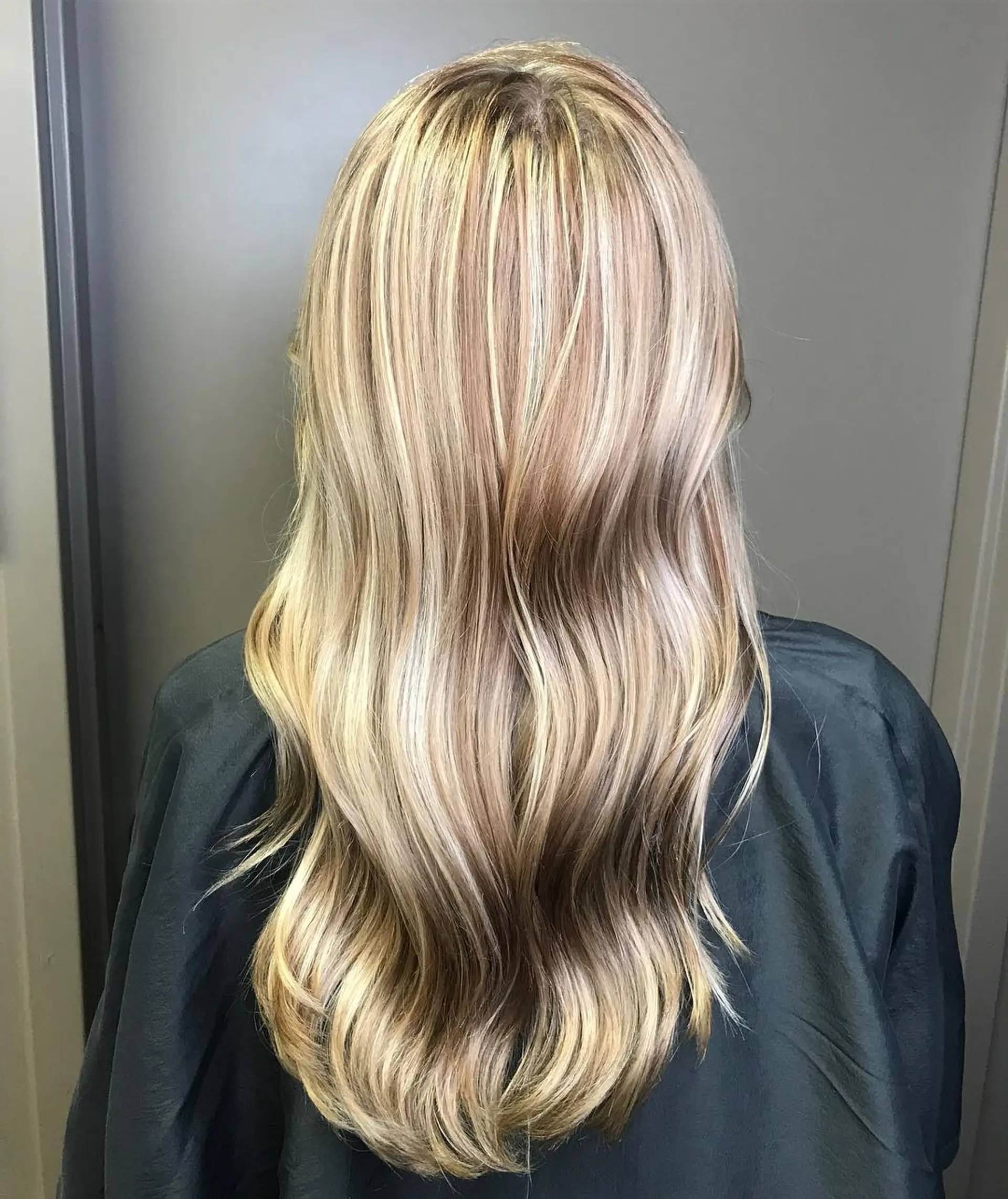 Long multi-tonal champagne blonde hair finished with soft, loose waves. 1