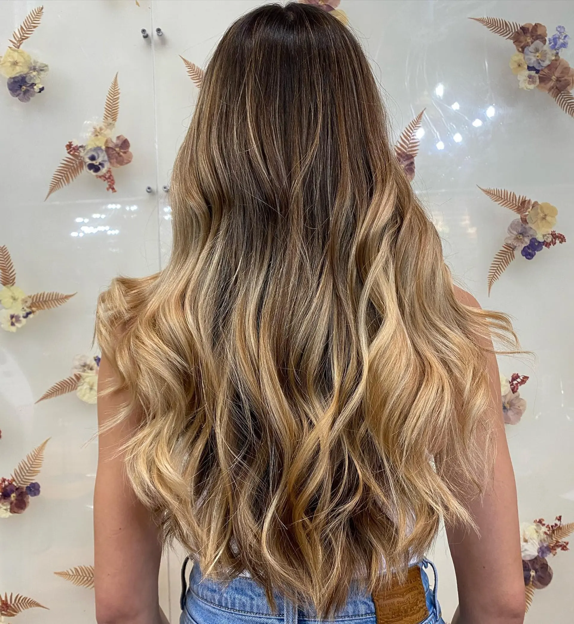 Long dimensional blonde balayage with seamless babylights cascading into soft, effortless waves. 1