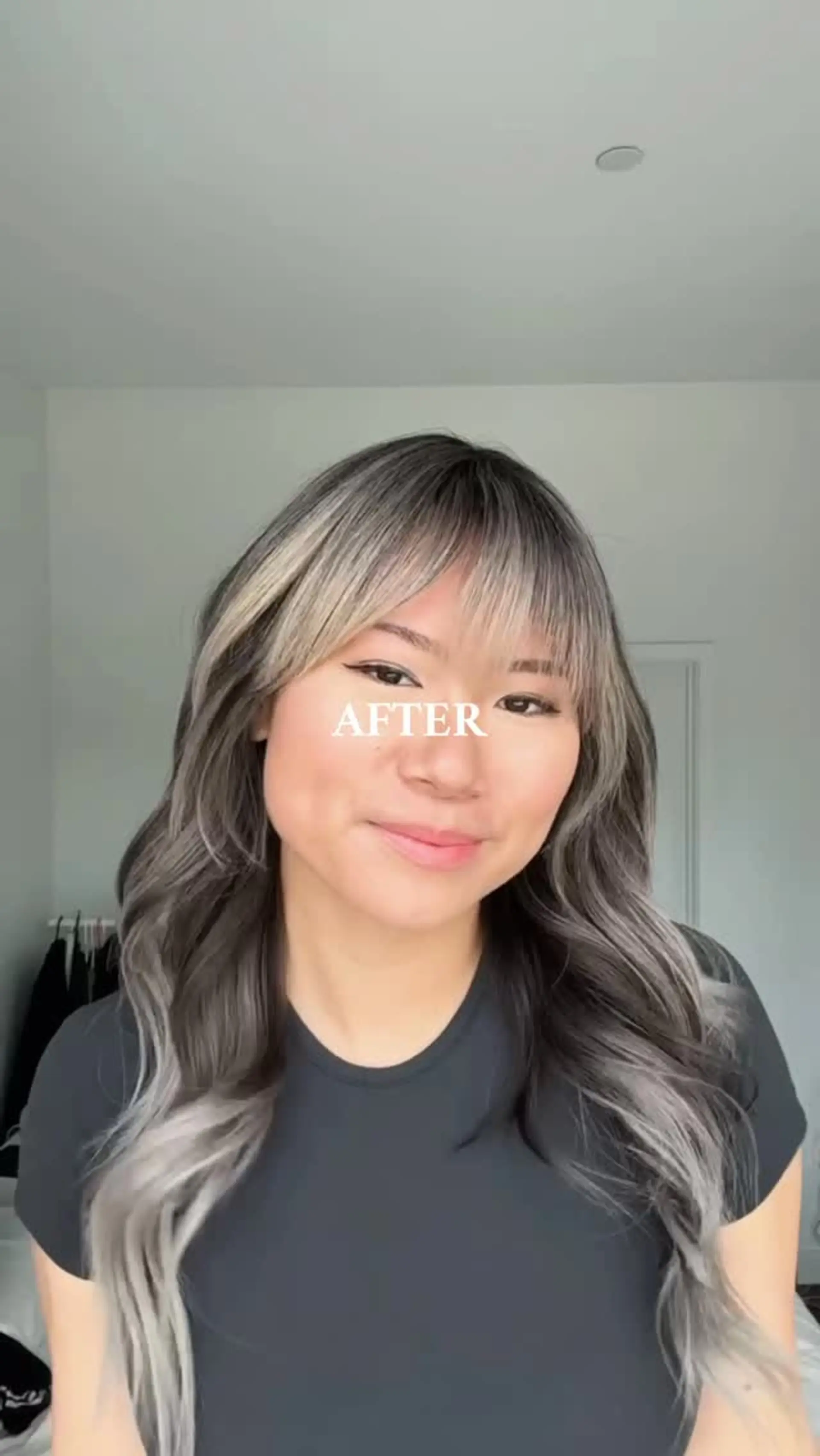Long, flowing hair colored in cool smoky ash blonde tones with face-framing highlights and a soft wispy fringe, styled into loose waves. 1