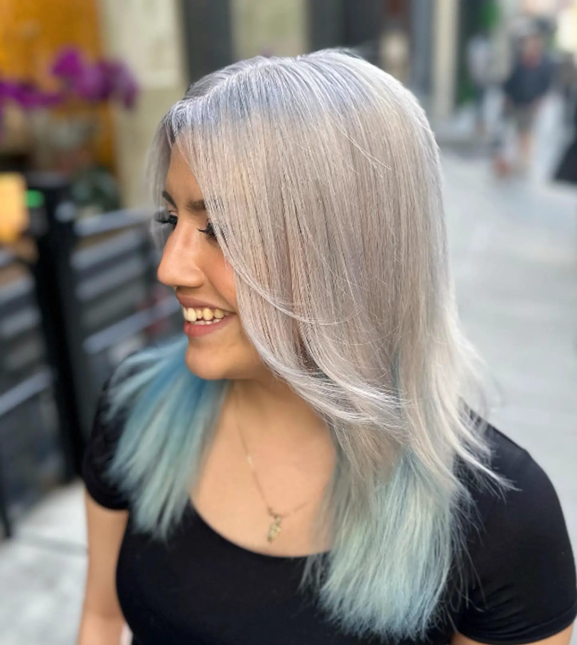 Medium-length, straight silver hair with soft waves and light blue ombre tips, featuring face-framing layers and a sleek finish.
 1