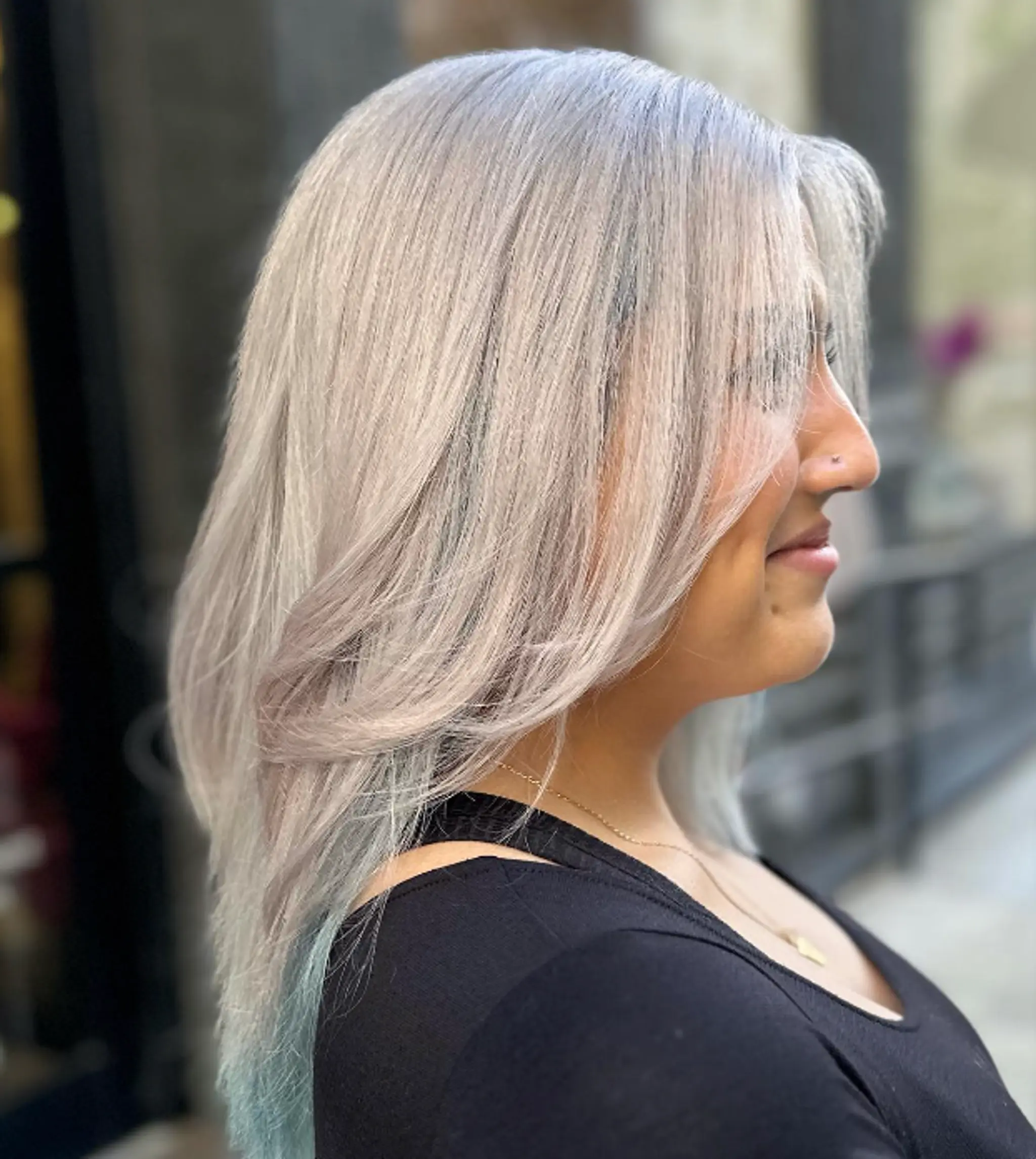 Medium-length, straight silver hair with soft waves and light blue ombre tips, featuring face-framing layers and a sleek finish.
 3