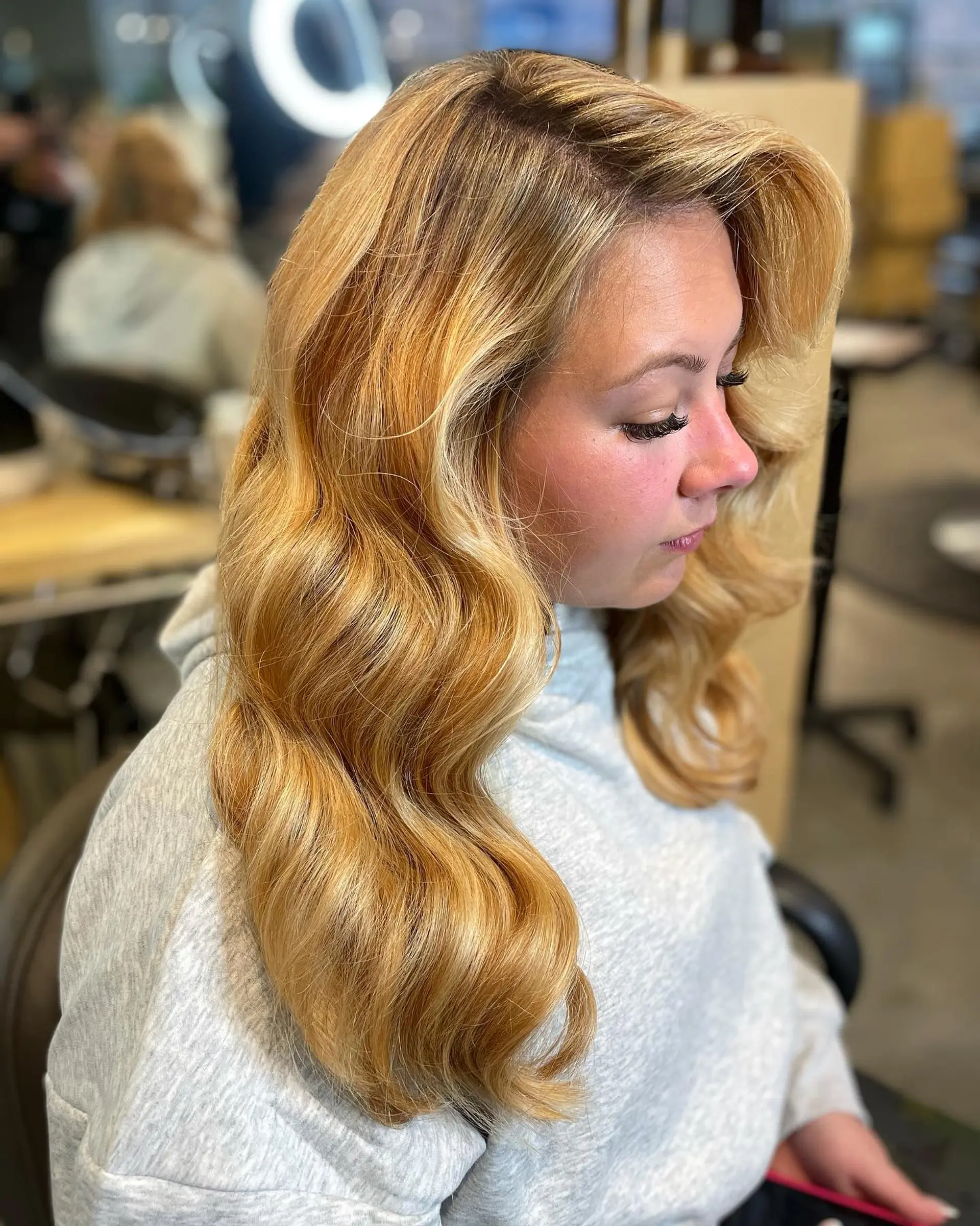 Long golden blonde hair styled in polished, voluminous Hollywood waves with a soft side swoop. 1