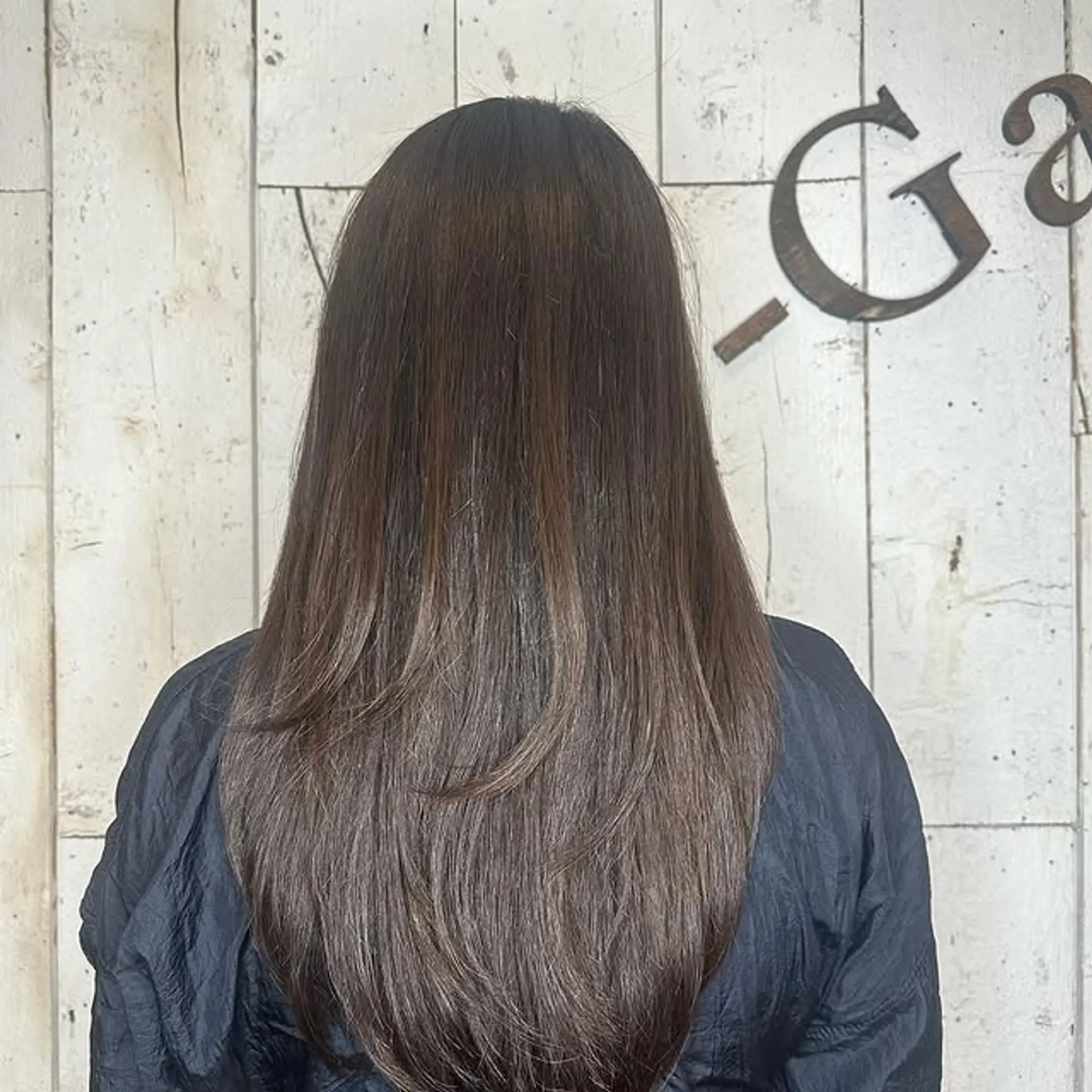 A long, layered hairstyle with subtle balayage highlights. 1