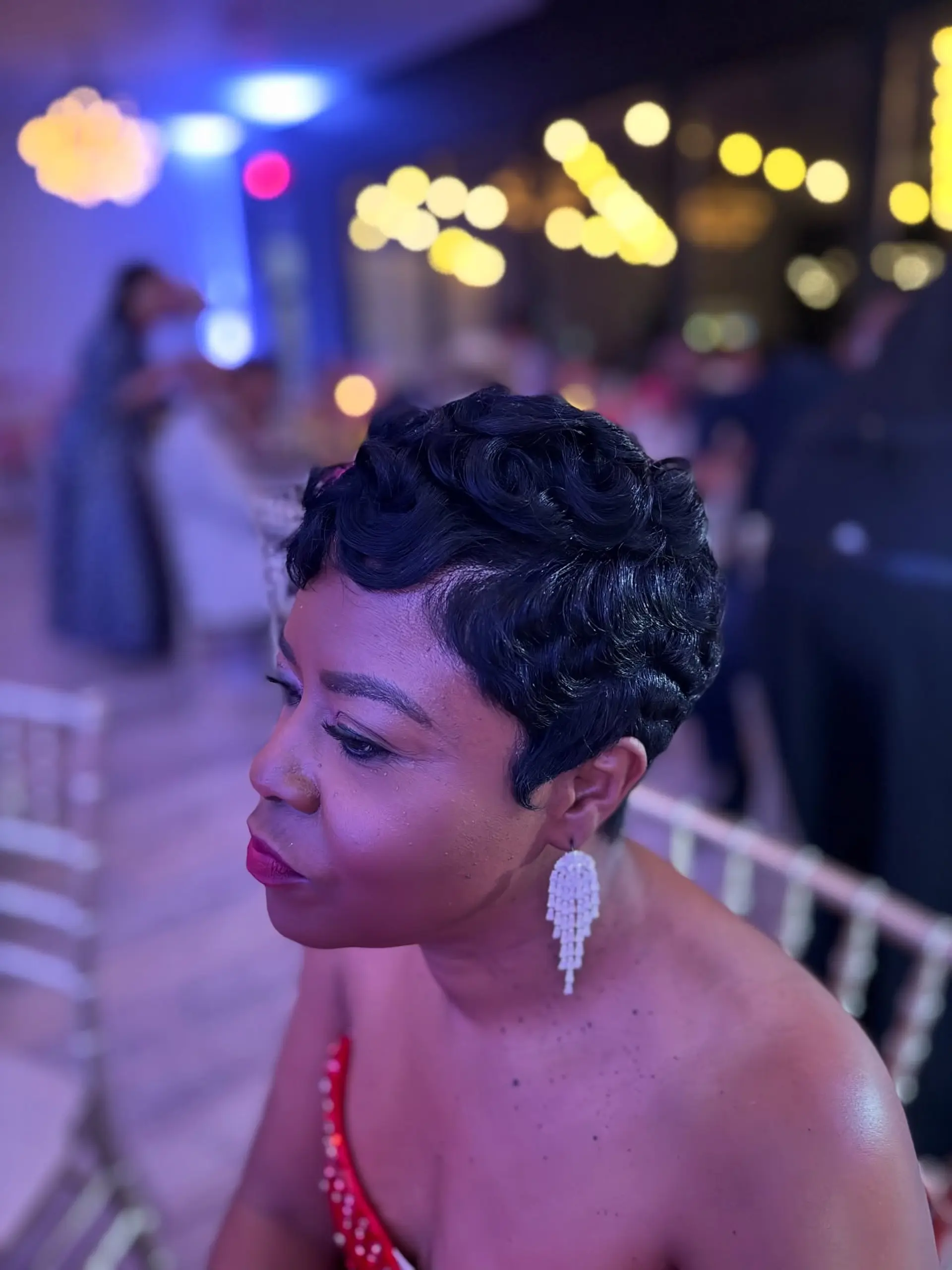 A sophisticated very short pixie cut featuring deeply defined, polished finger waves that beautifully frame the face and head, offering a timeless and elegant aesthetic. 2