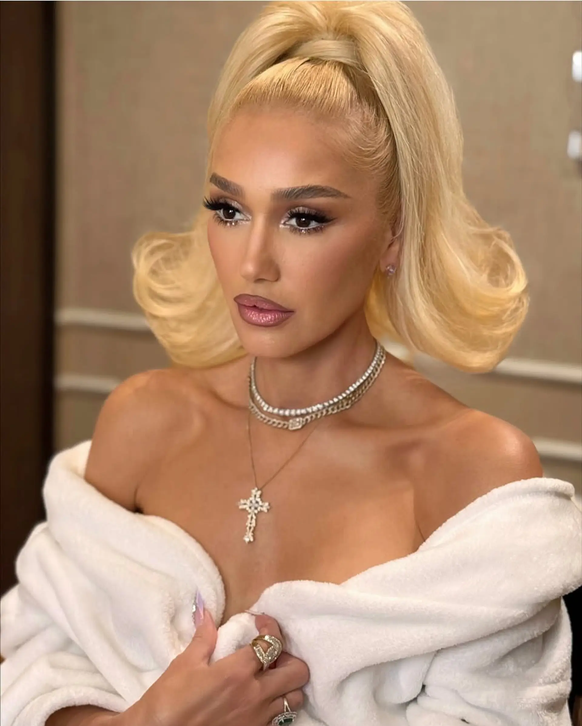 A retro-inspired high half-up ponytail featuring slicked-back front hair, a wrapped base, and large flipped-out voluminous ends. 1