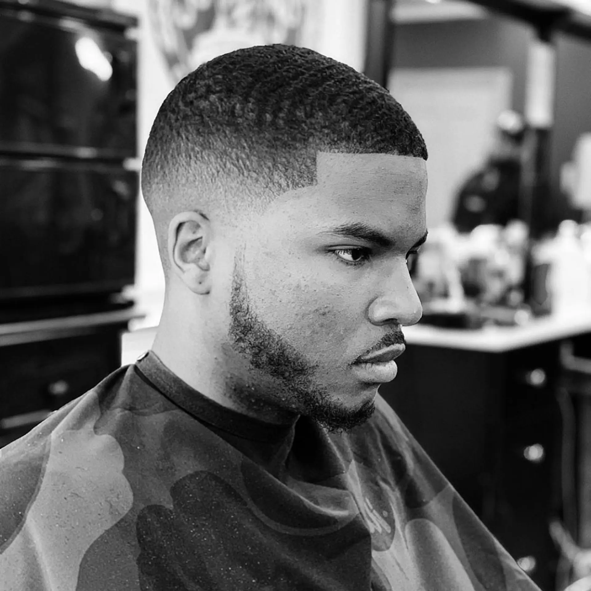 A sharp mid fade paired with short textured brush waves on top and a crisp edge up. 1