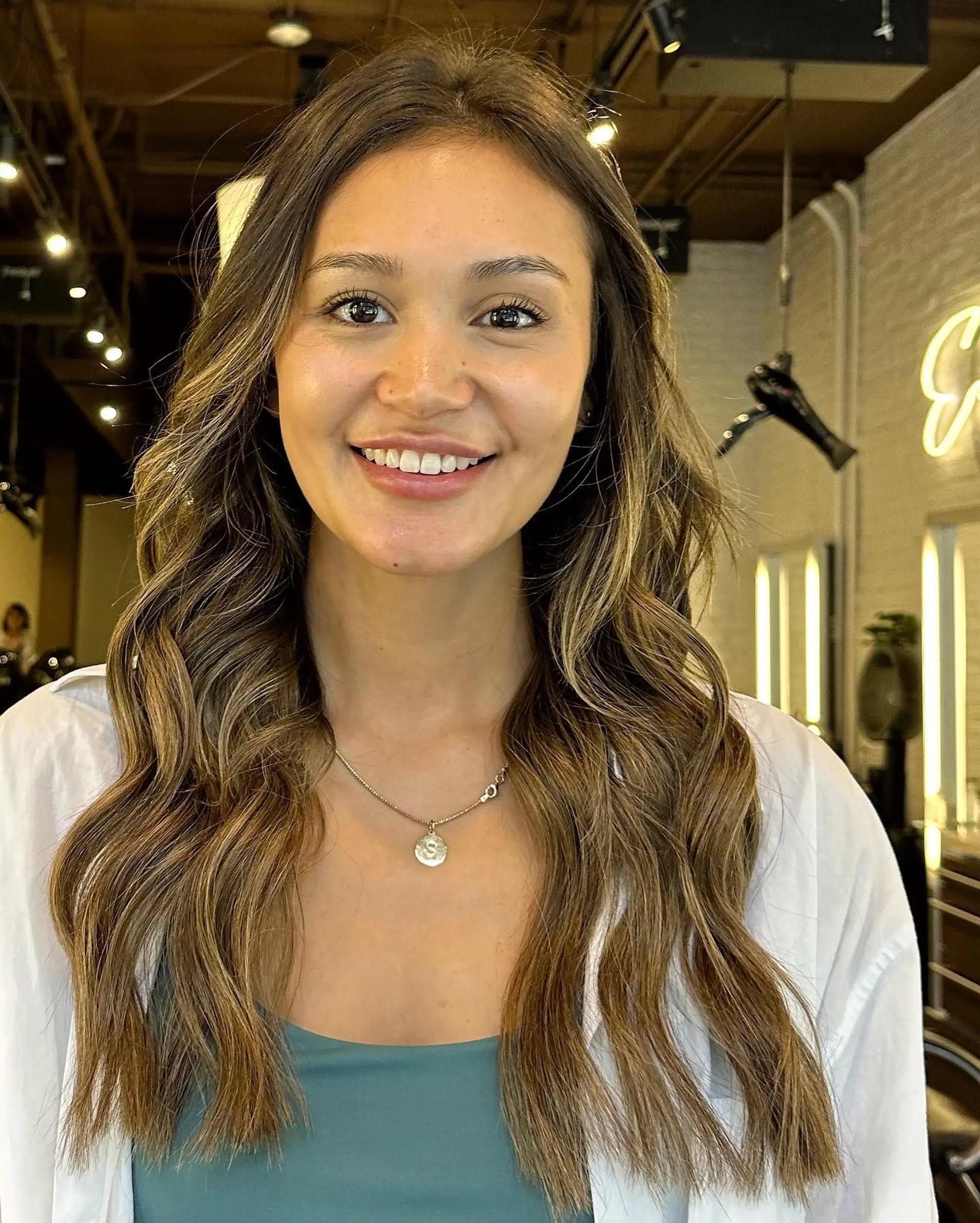 Long, layered wavy hair with a bronde balayage. 1