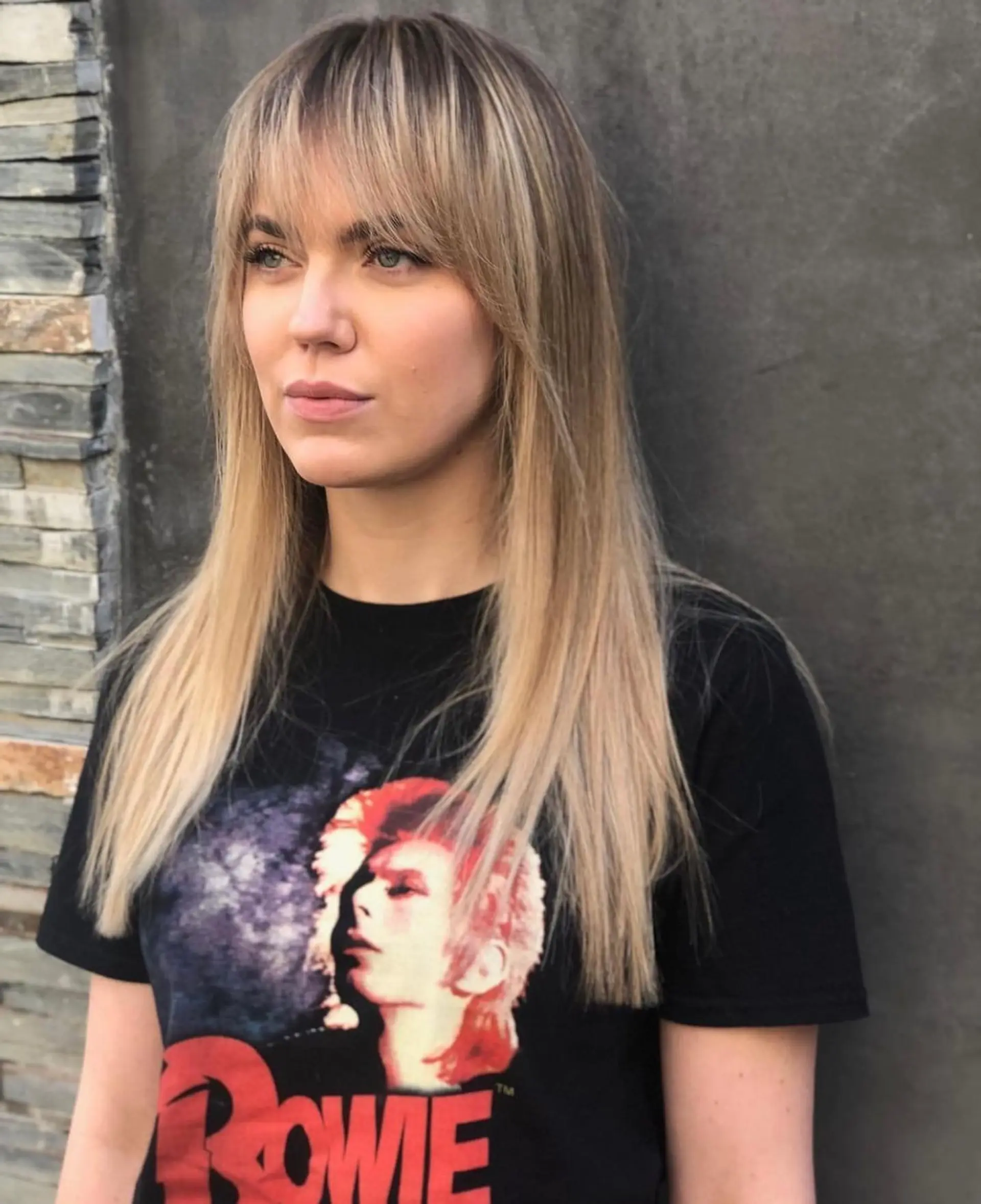Long straight blonde hair styled with full, wispy fringe bangs and soft face-framing layers. 1